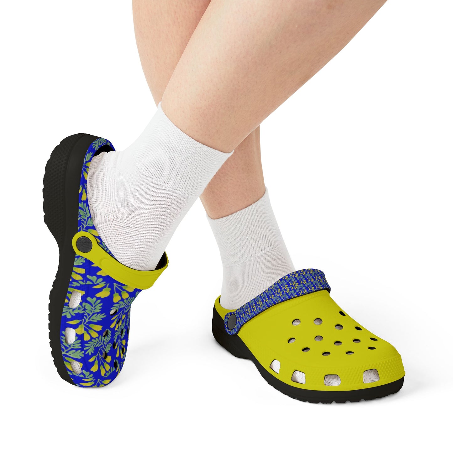 Blue floral and neon yellow slip-on clogs worn with white socks.