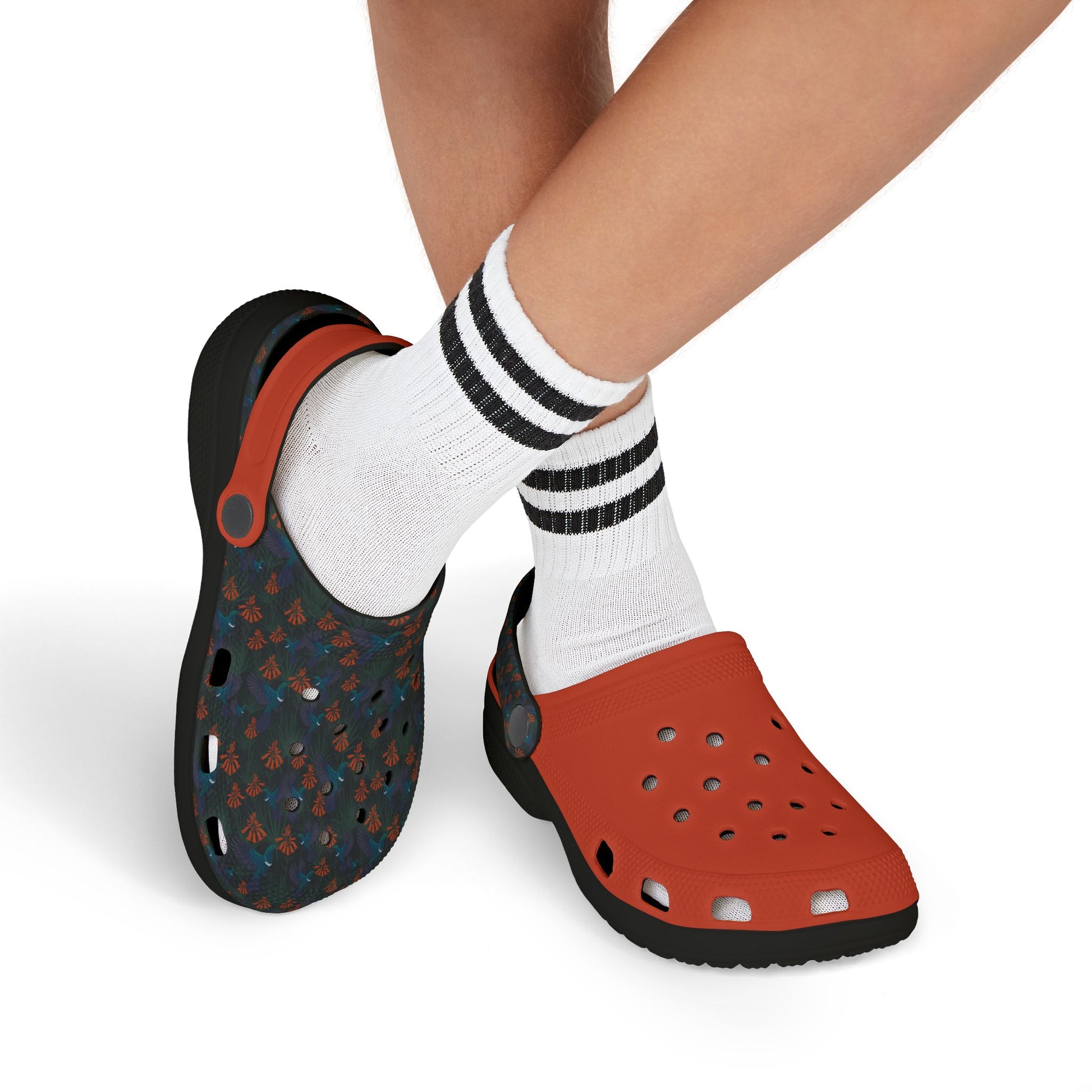 Kids' clog-style casual shoes on model feet: dark blue patterned clog and orange clog