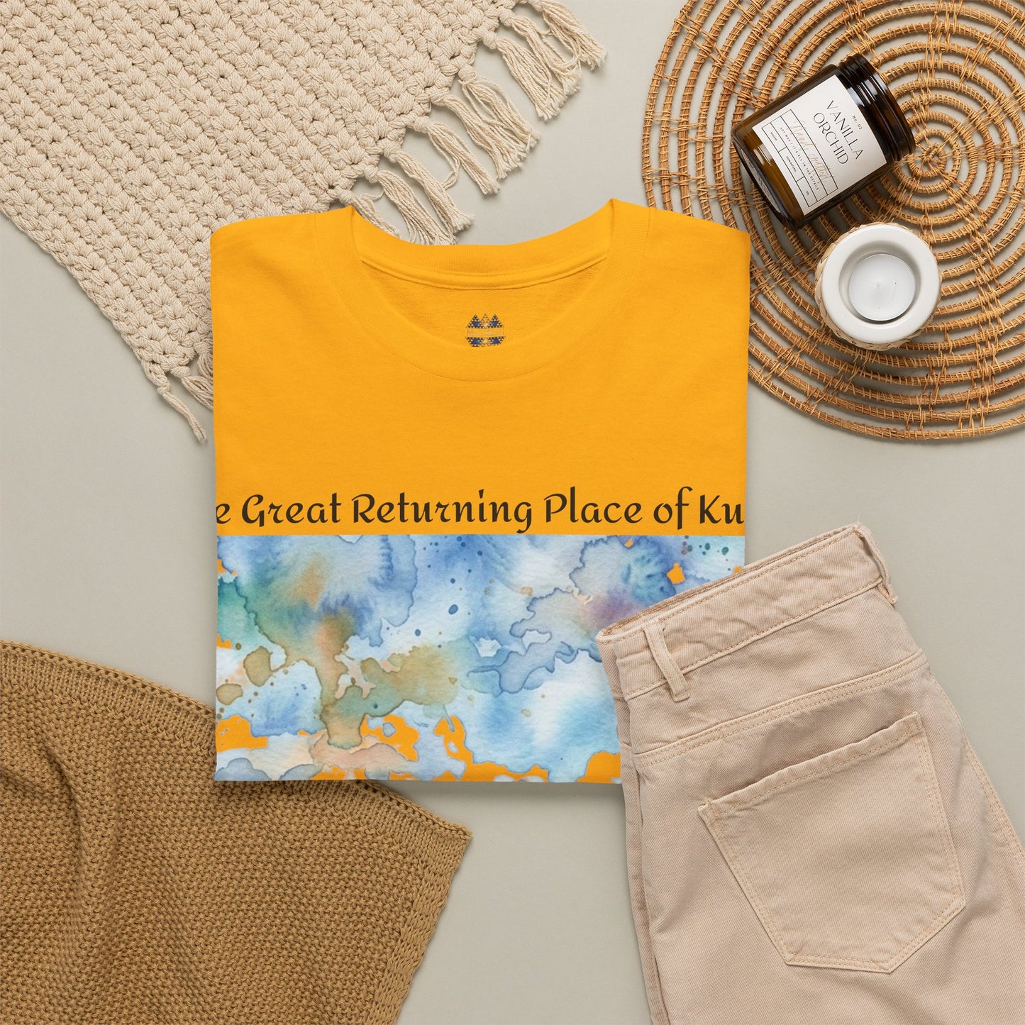 Yellow Hokianga Harbour T-shirt laid flat with landscape artwork and crew neckline