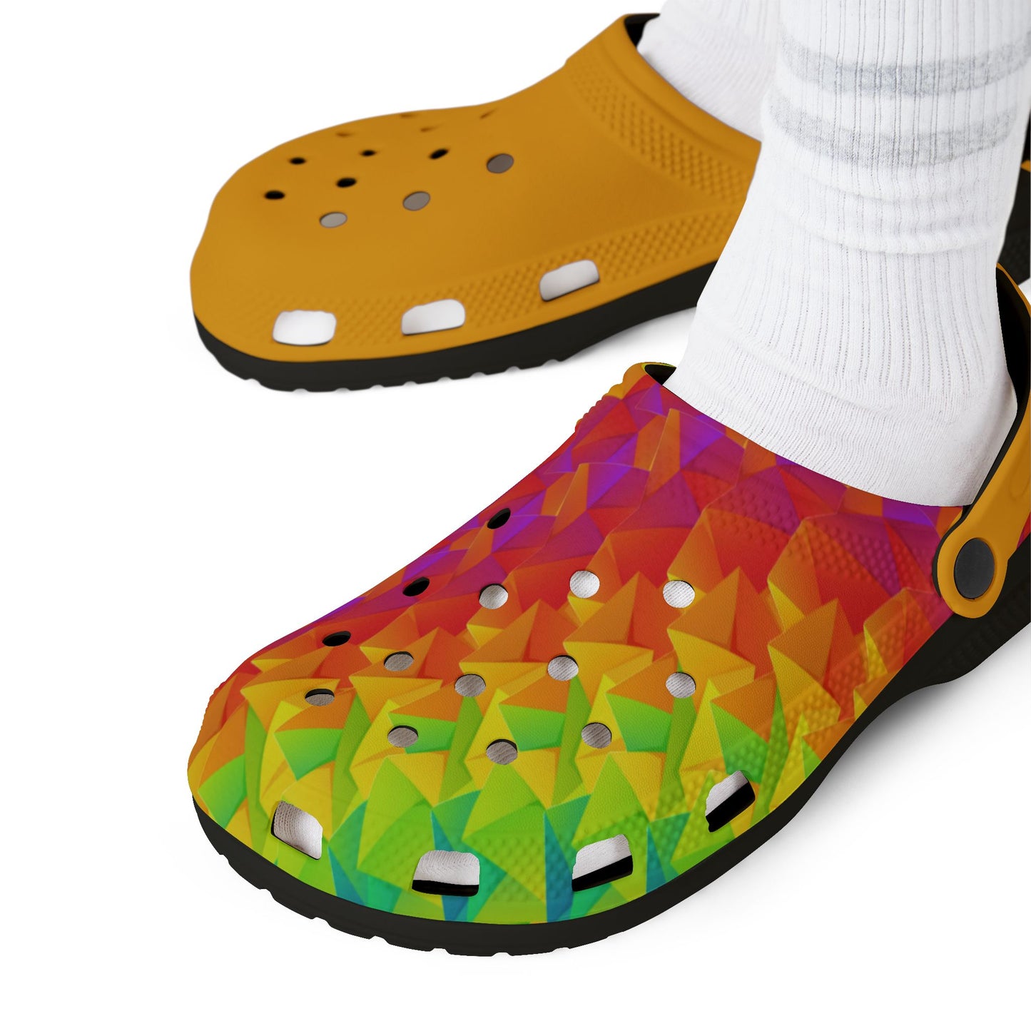 Ahi clogs on white socks, yellow upper with multicolor geometric print, black outsole.