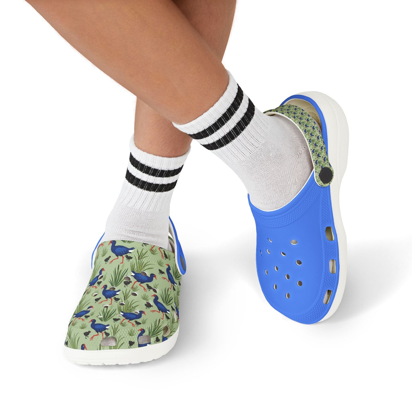 Kids shoes worn with white striped socks; green print clogs with blue back, white sole.