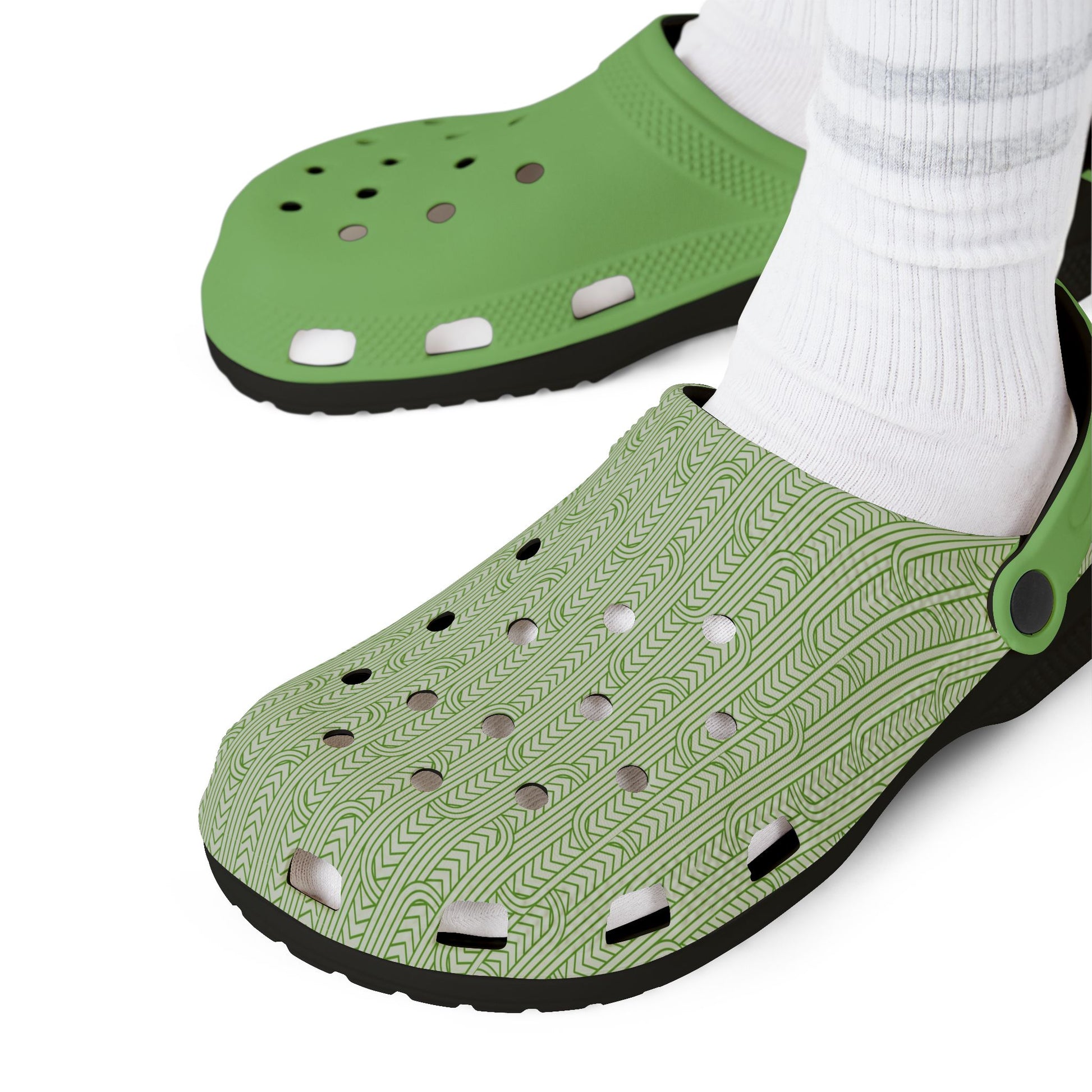 Green clog sandals close-up, perforated textured upper and black tread sole