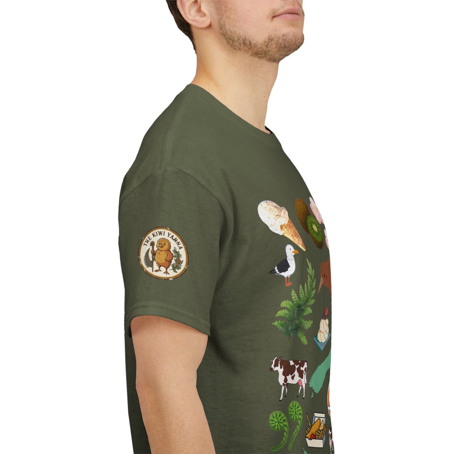 Dark green crewneck T-shirt with sleeve emblem and colorful Kiwiana-themed graphic