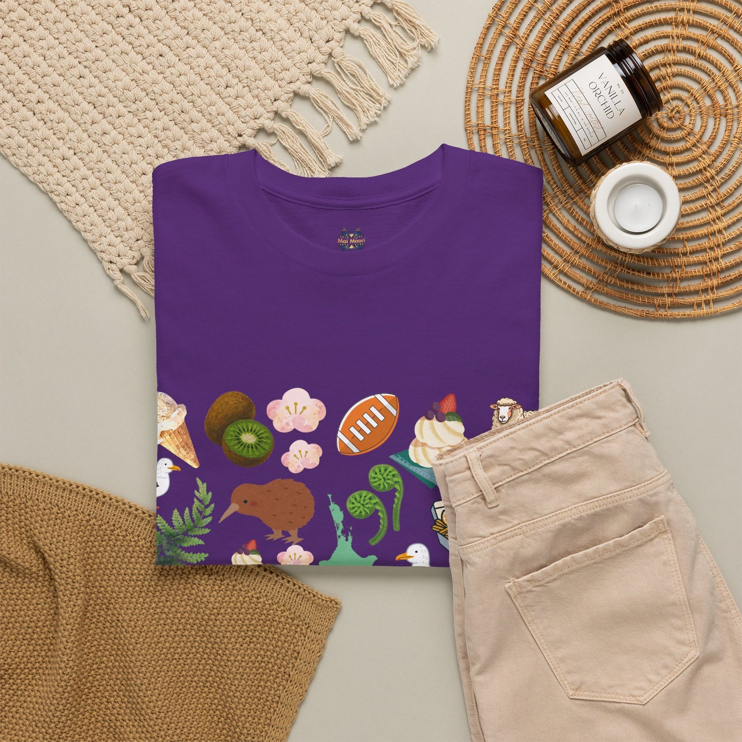 Kiwiana graphic T-shirt flat lay in purple, crew neck with wildlife art print front
