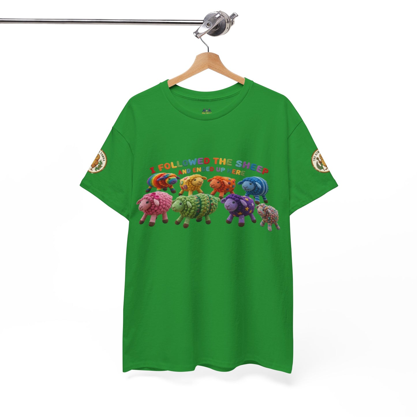 Green crew-neck t-shirt hanging up, colorful sheep graphic centered on chest