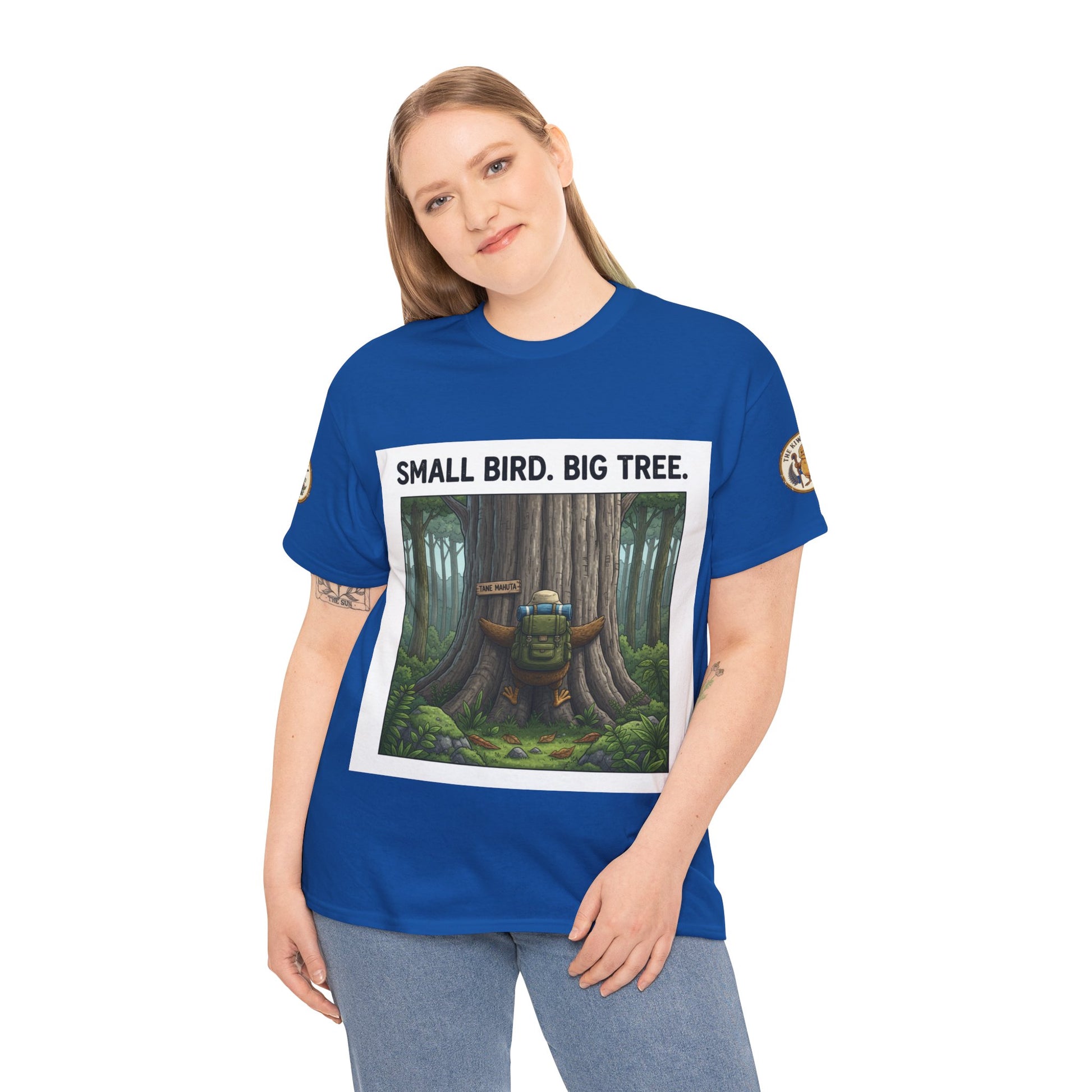 Blue crew-neck T-shirt worn by model, featuring “Small Bird. Big Tree.” forest graphic