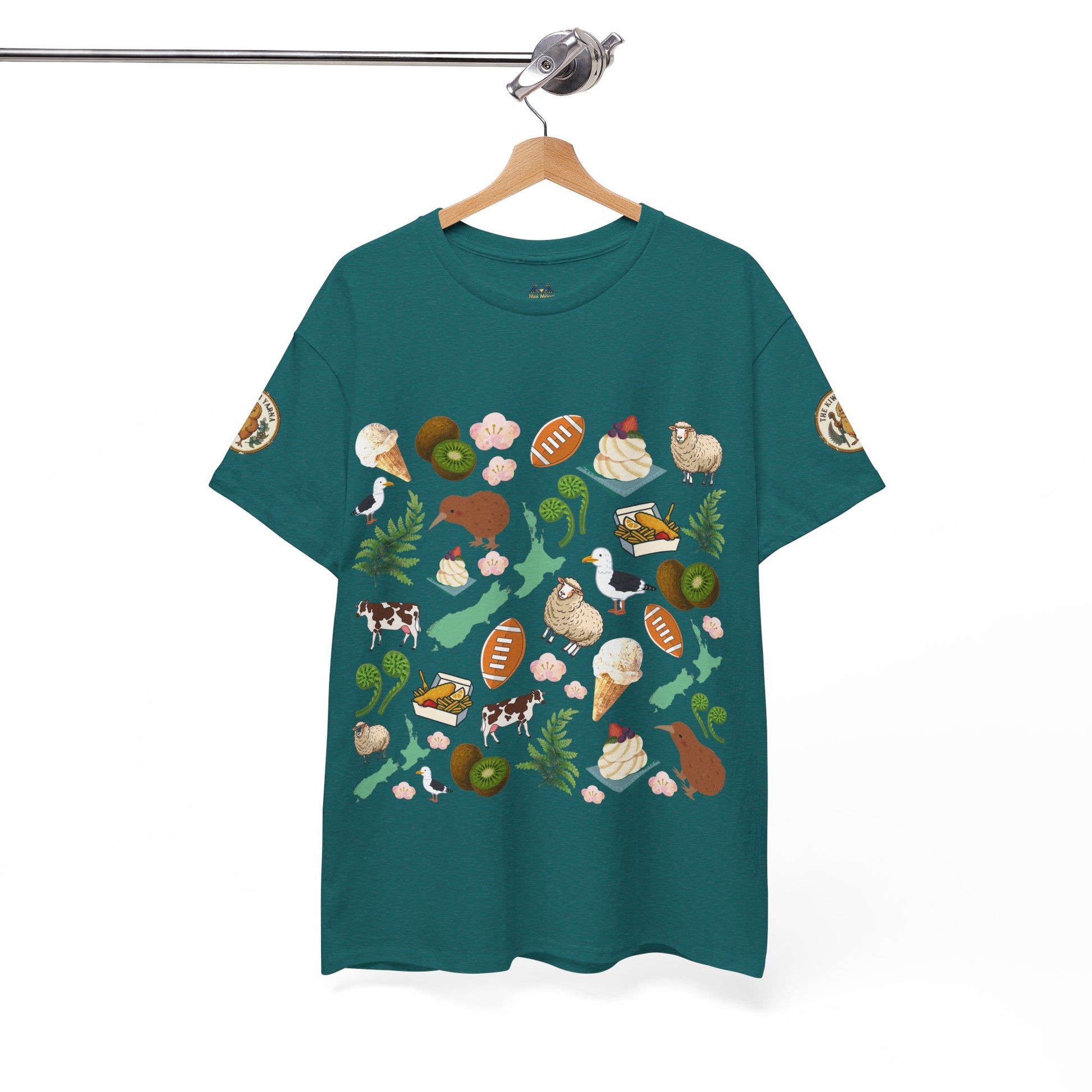 Teal crewneck T-shirt on hanger with scattered Kiwiana-themed icons and animals (front)