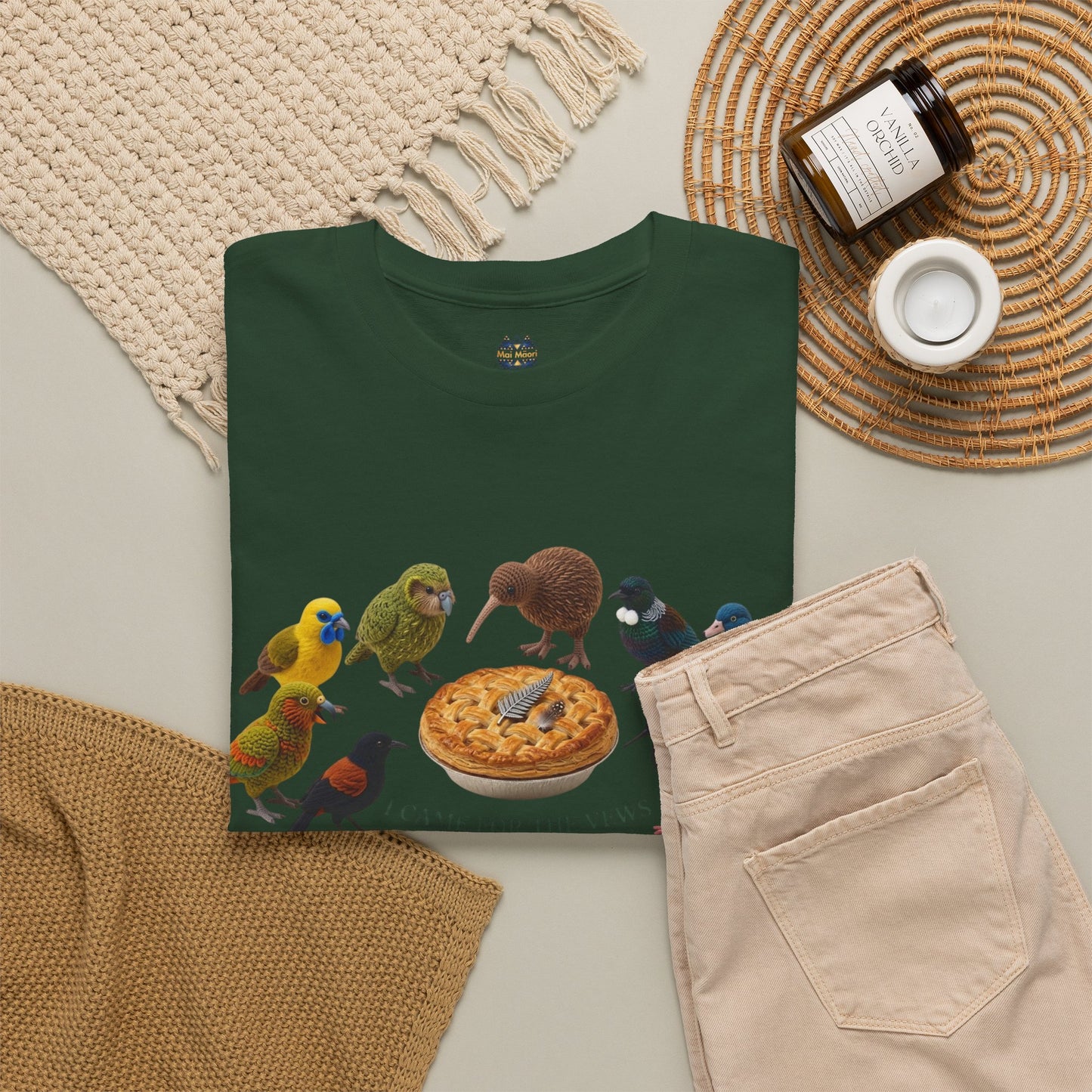 Dark green T-shirt laid flat with birds-and-pie print, crew neck top view