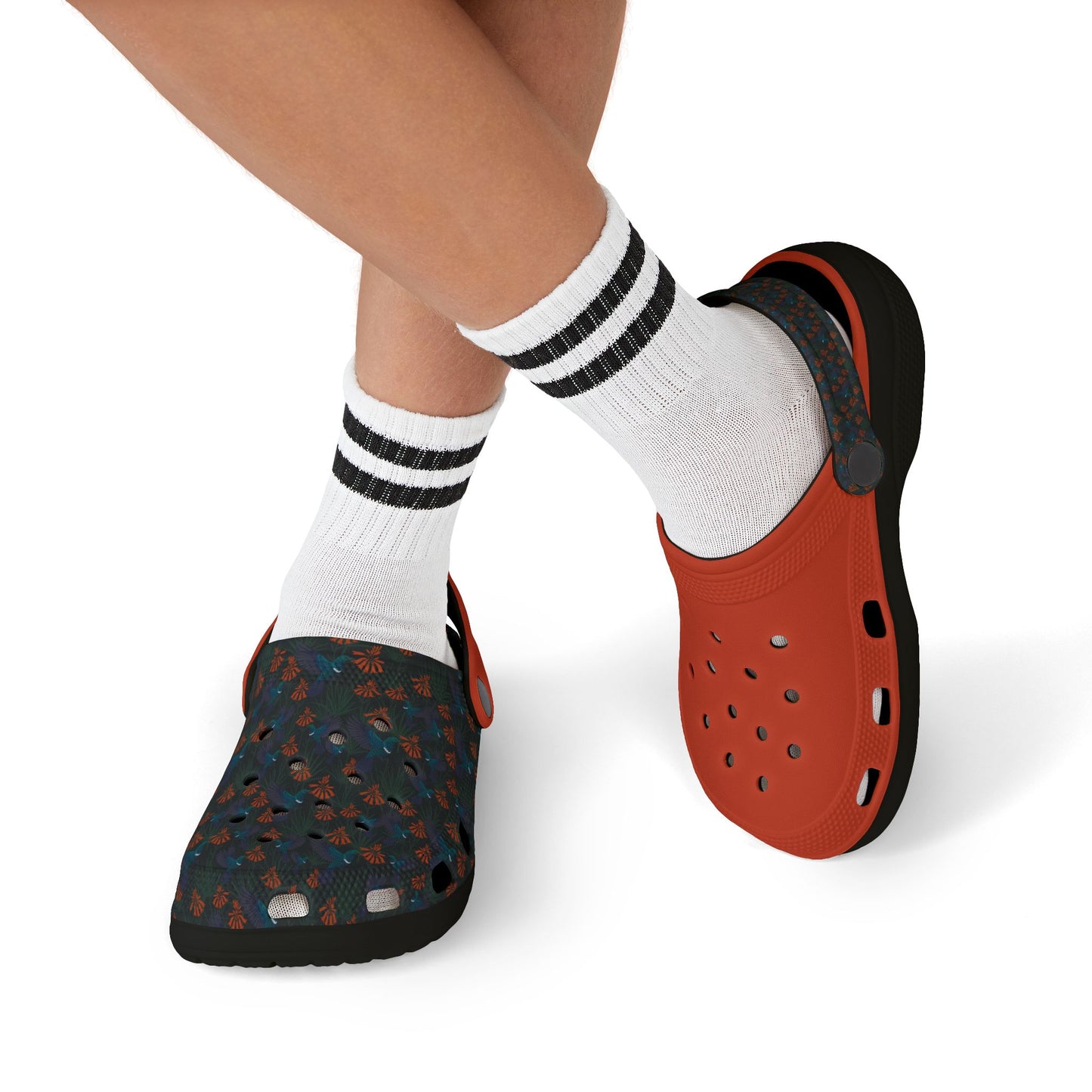 Kids' clog-style casual shoes on model feet: orange clog and dark blue patterned clog