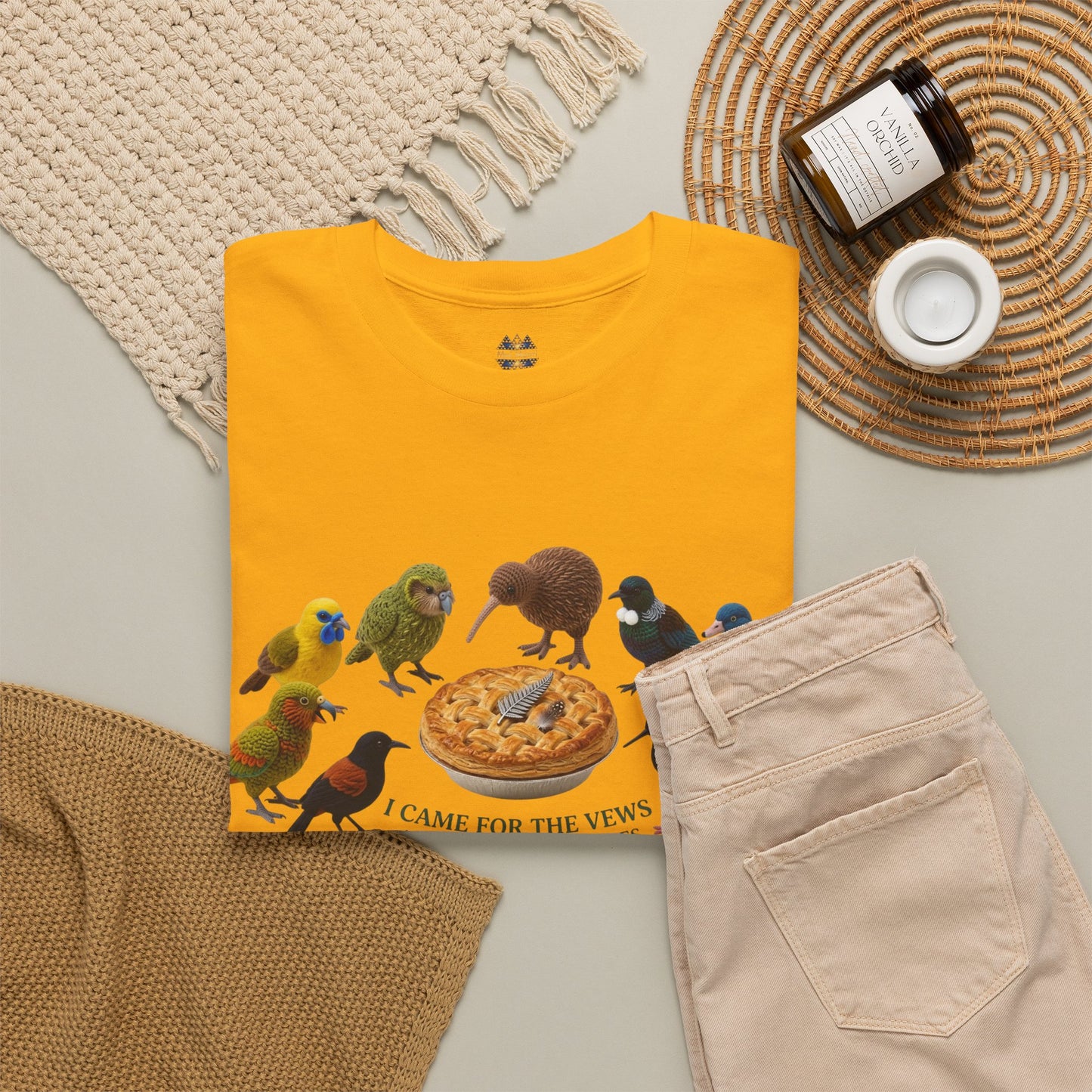 Yellow T-shirt with bird and pizza graphic, styled with light beige pants