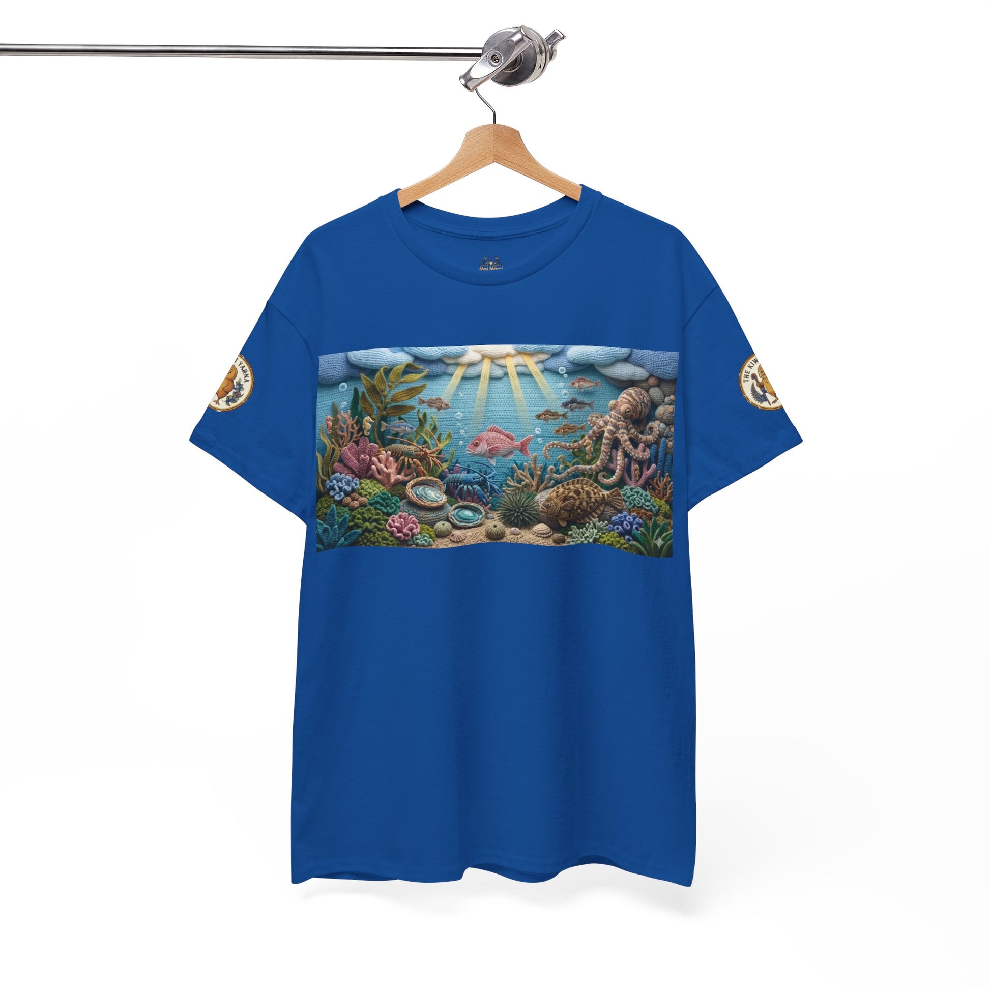 Blue crewneck T-shirt on hanger with rectangular undersea graphic and circular sleeve patch