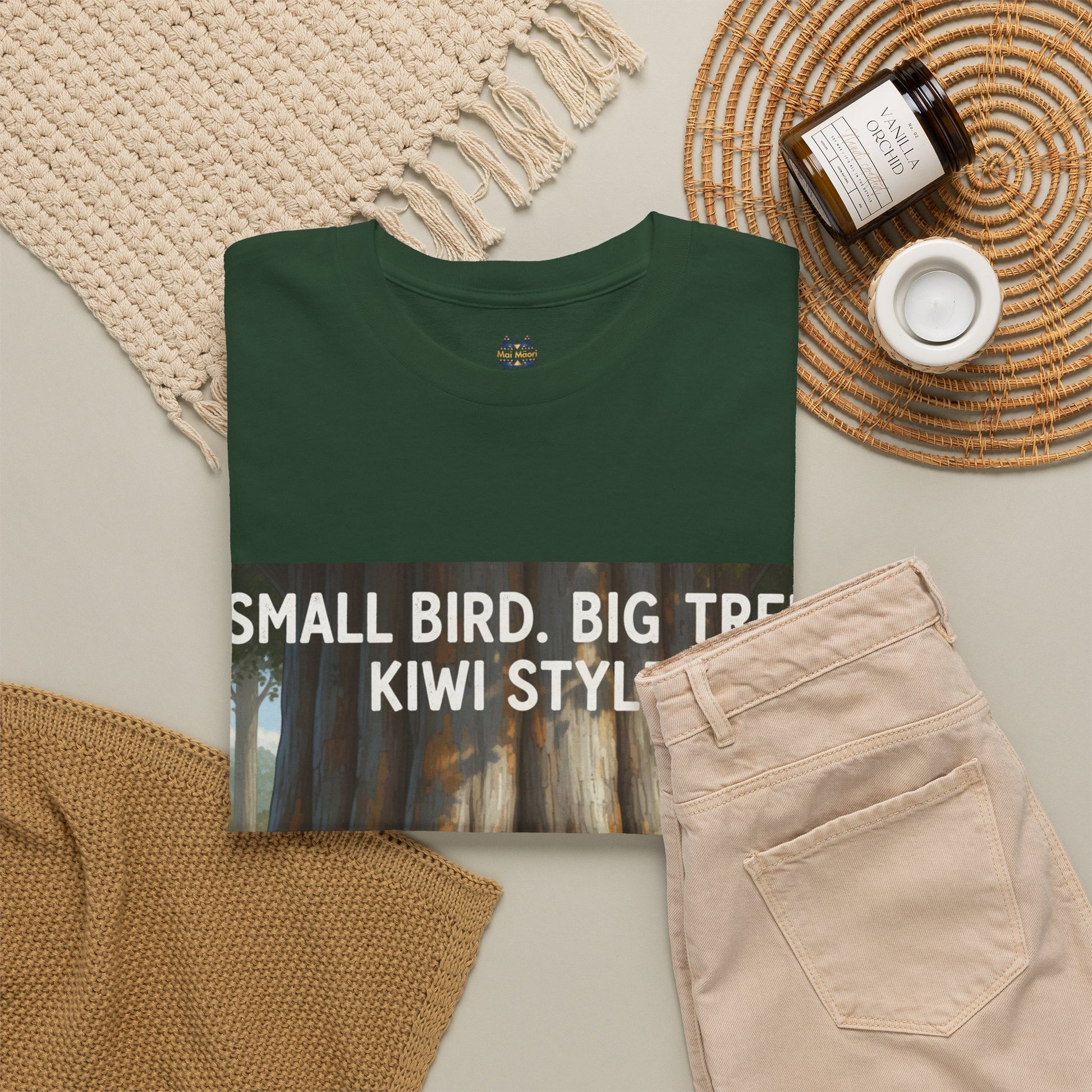 Dark green graphic t-shirt front view with print text: Small Bird Big Tree Kiwi Style