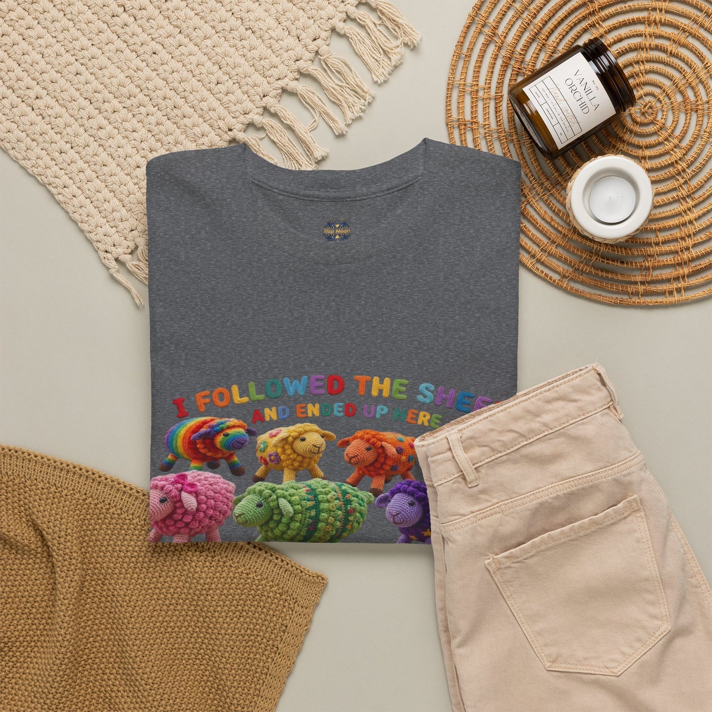 Charcoal gray T-shirt laid flat with colorful sheep graphic across the chest