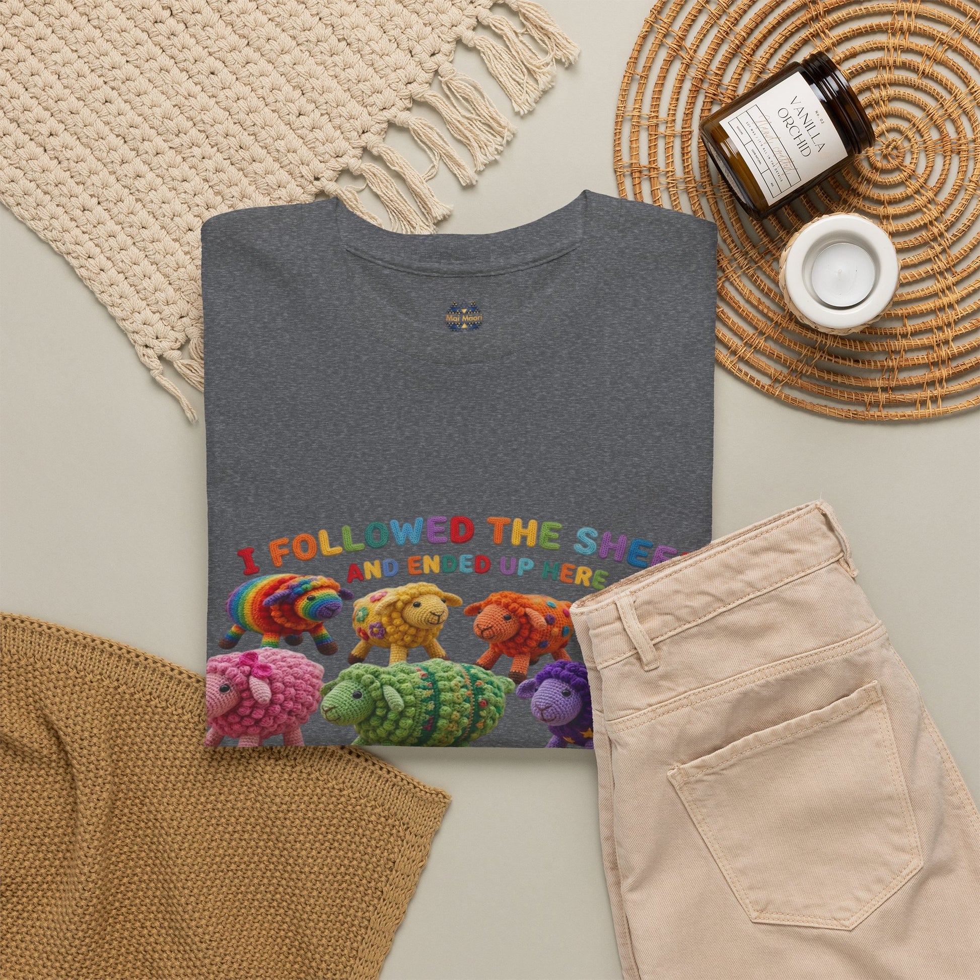 Charcoal gray T-shirt laid flat with colorful sheep graphic across the chest