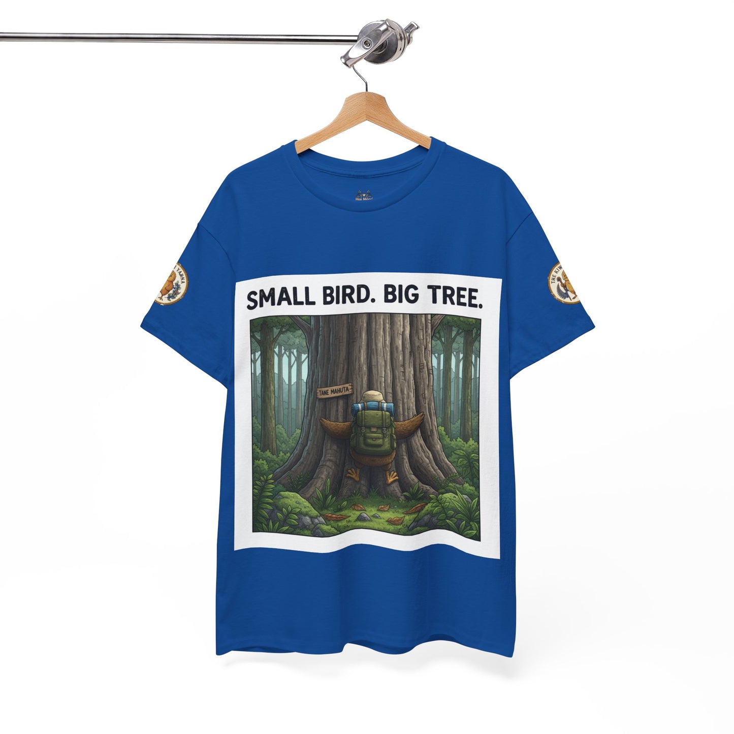 Blue crew-neck T-shirt hanging up with centered “Small Bird. Big Tree.” forest graphic