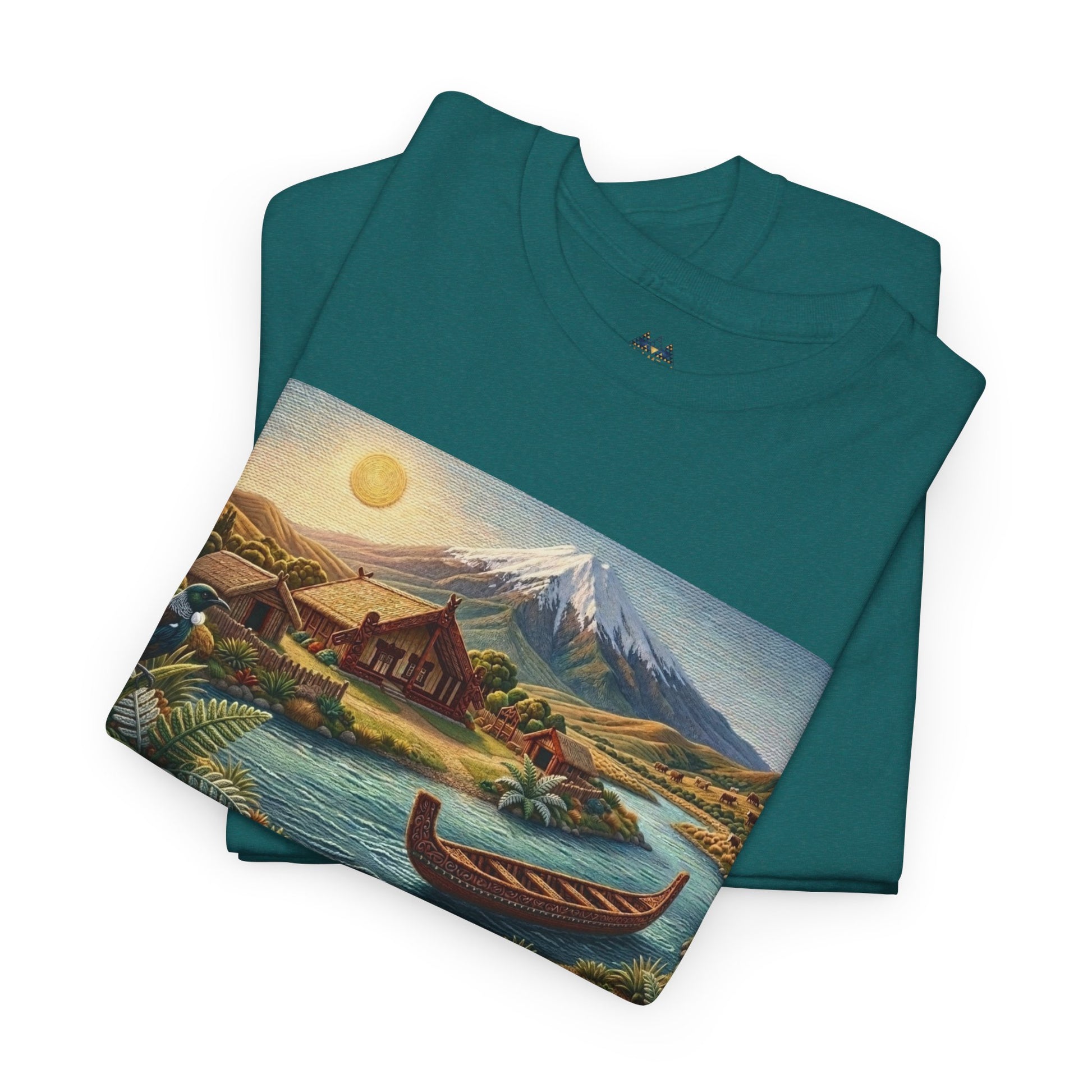 Green crewneck T-shirt folded with large landscape graphic featuring a canoe and mountain.