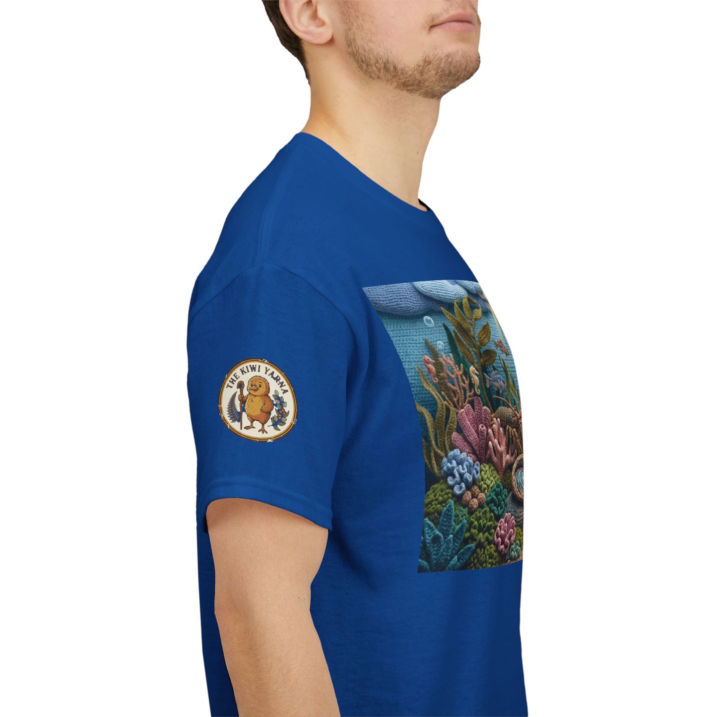 Blue T-shirt side view with rectangular undersea chest graphic and circular sleeve patch
