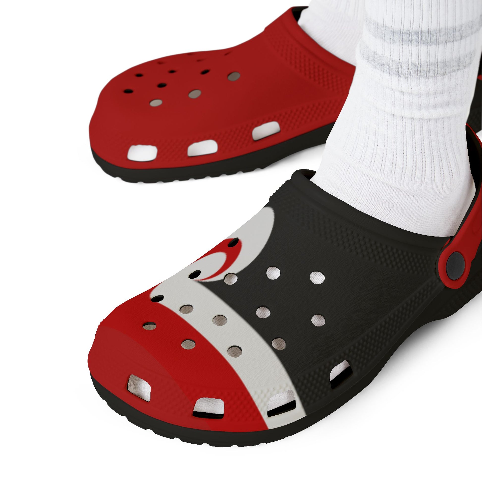 Red and black clogs with perforated top, molded holes, and white socks