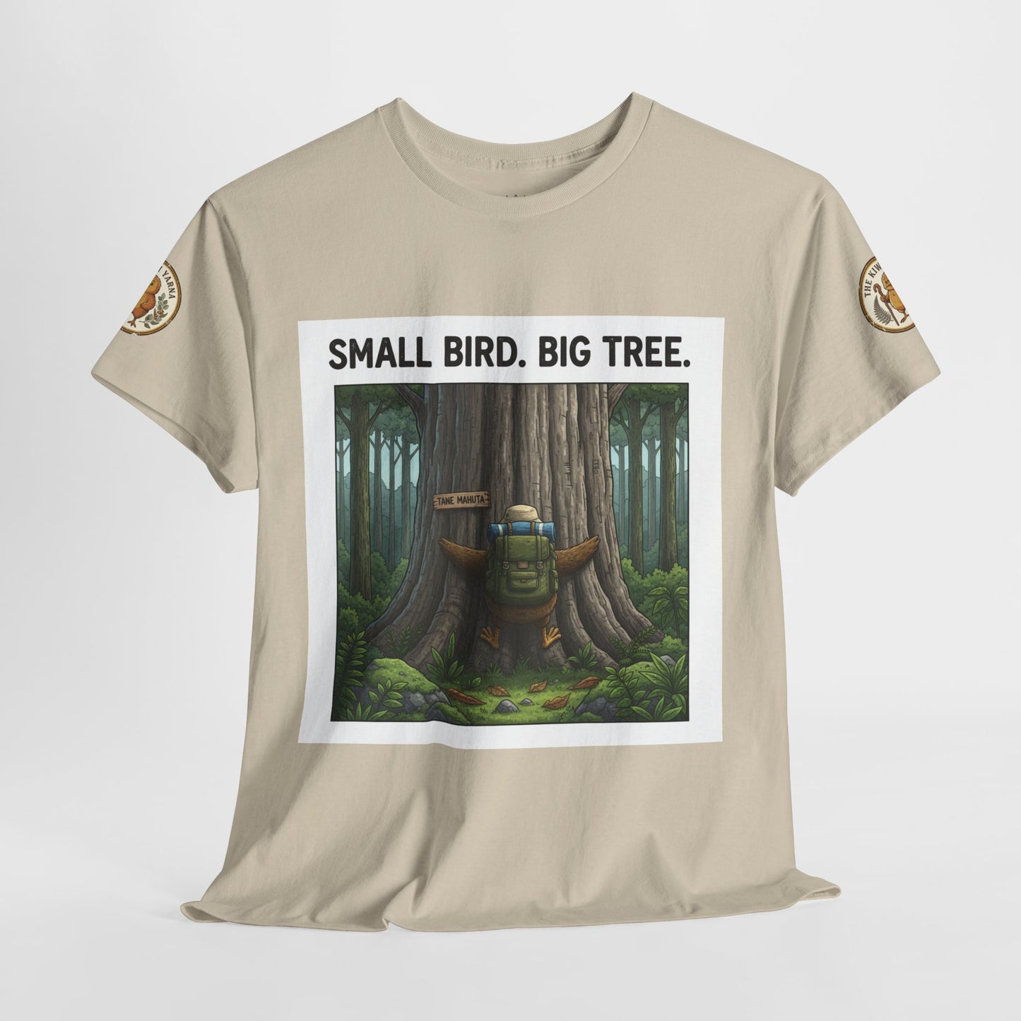 Beige graphic T-shirt with square forest scene and 'SMALL BIRD. BIG TREE.' text