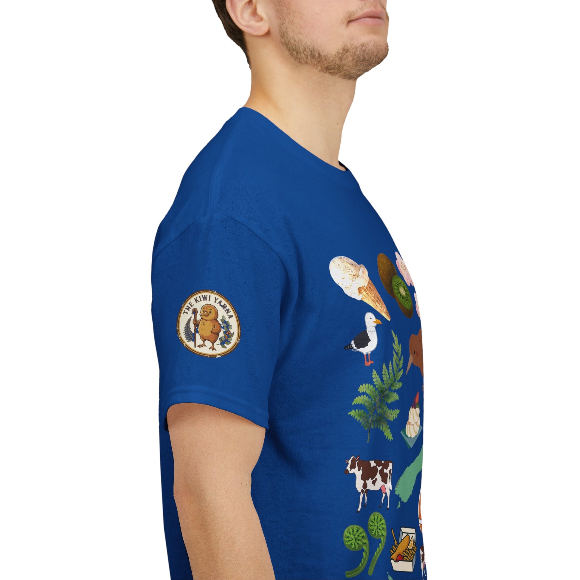 Kiwiana graphic T-shirt on model side in antique sapphire blue with sleeve patch and print