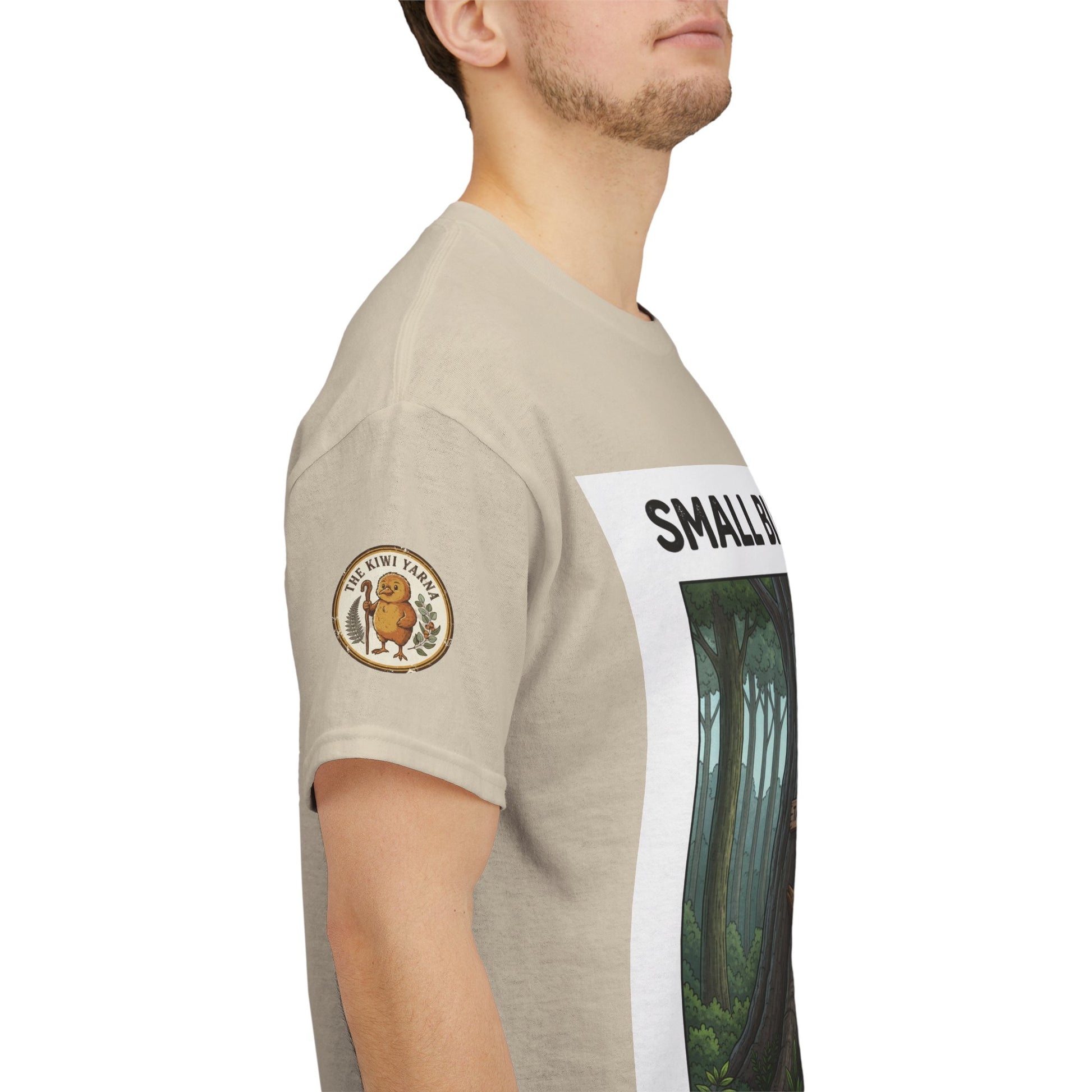 Beige T-shirt side view with round sleeve patch and partial 'SMALL' print