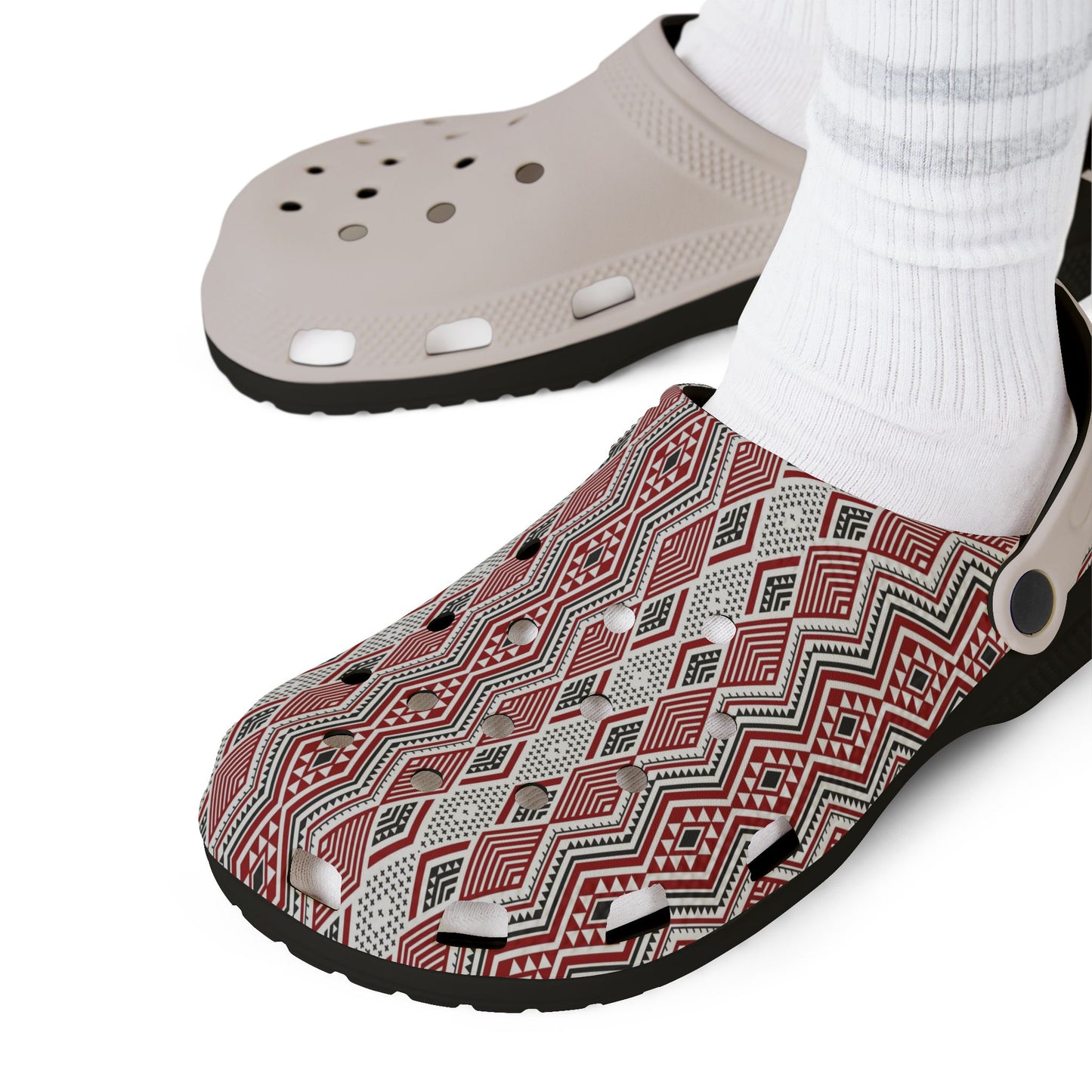 Pair of slide clogs with white perforated uppers and red geometric fabric panels.