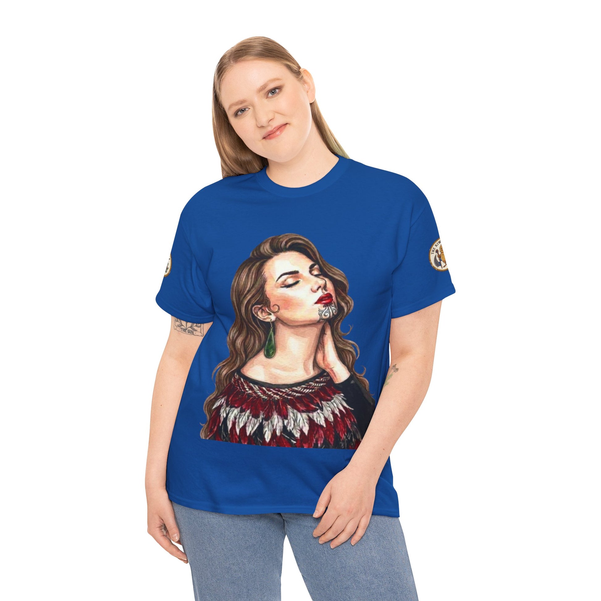 Model wearing royal blue graphic T-shirt with portrait print and green-red fringe detail.