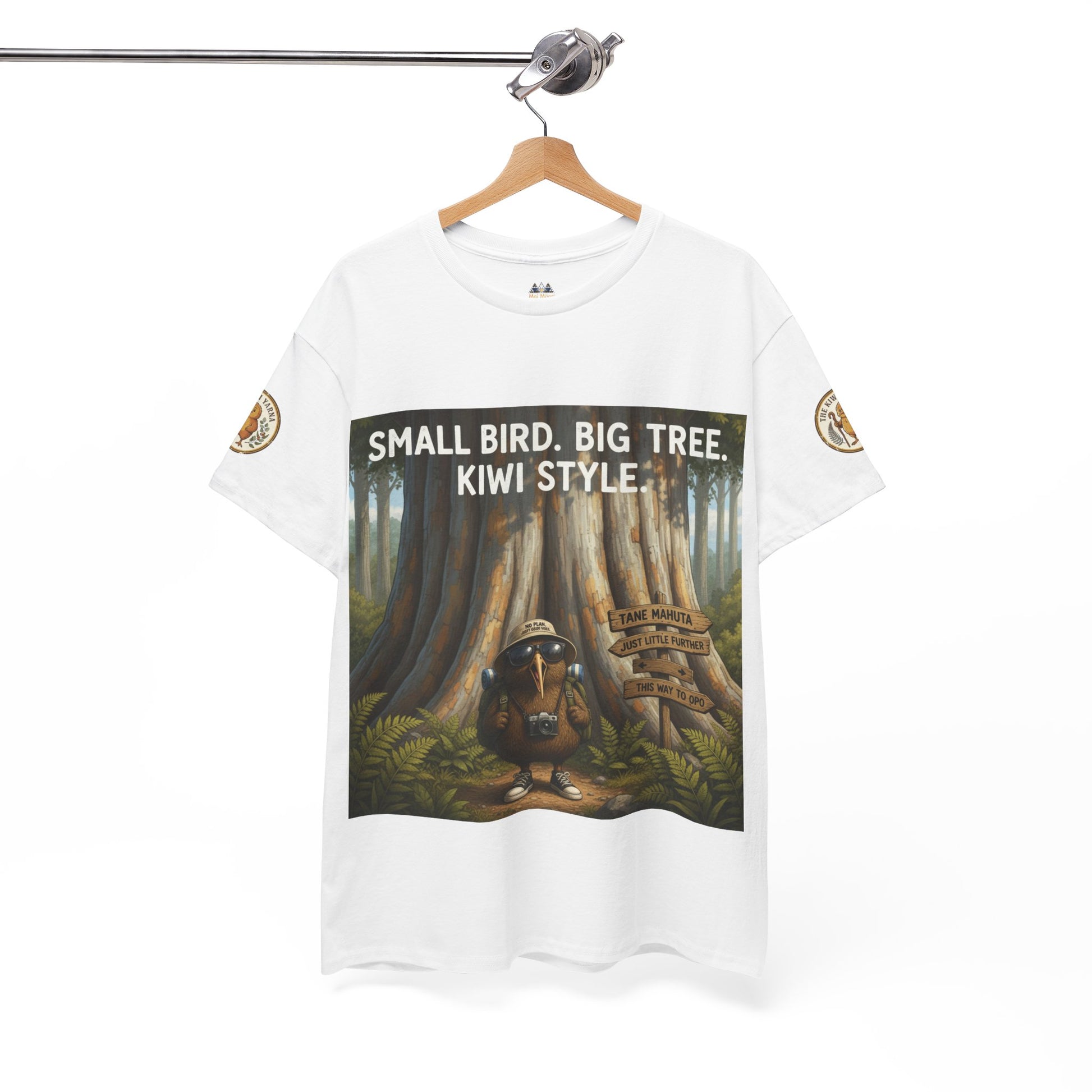 White T-shirt on hanger with centered forest graphic and “SMALL BIRD, BIG TREE” text