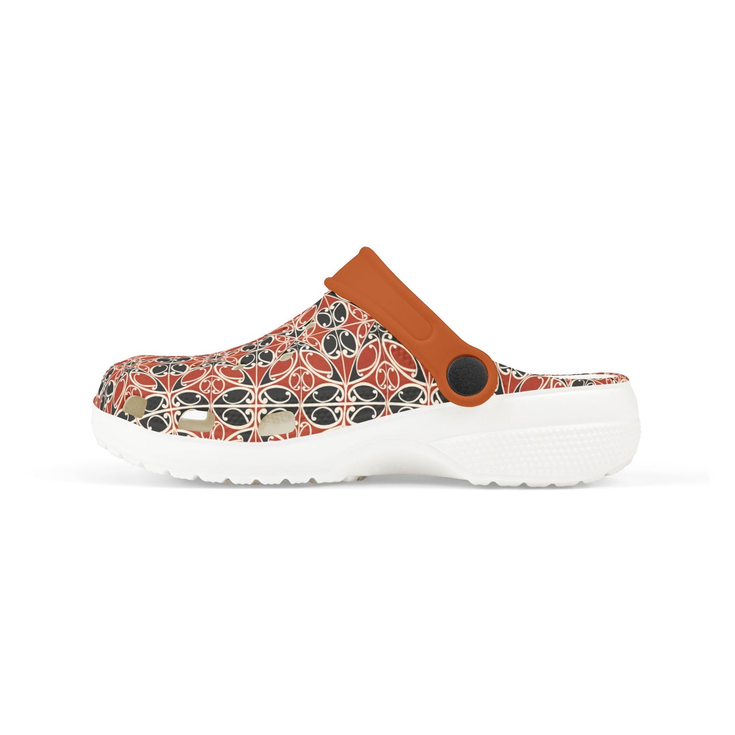 Māoritanga slide clogs with patterned upper and tan strap, black circular accent, white sole