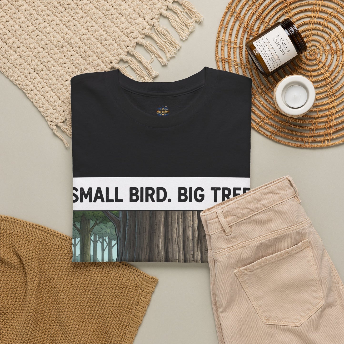 Black T-shirt with large front forest graphic; paired with light pants in the layout