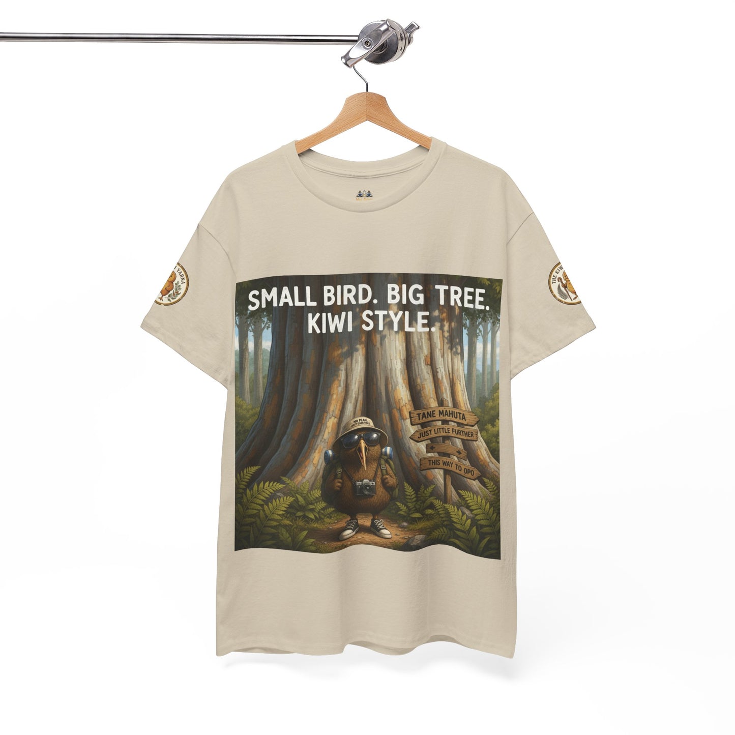 Beige short-sleeve T-shirt on hanger with forest graphic and 'Kiwi Style' text