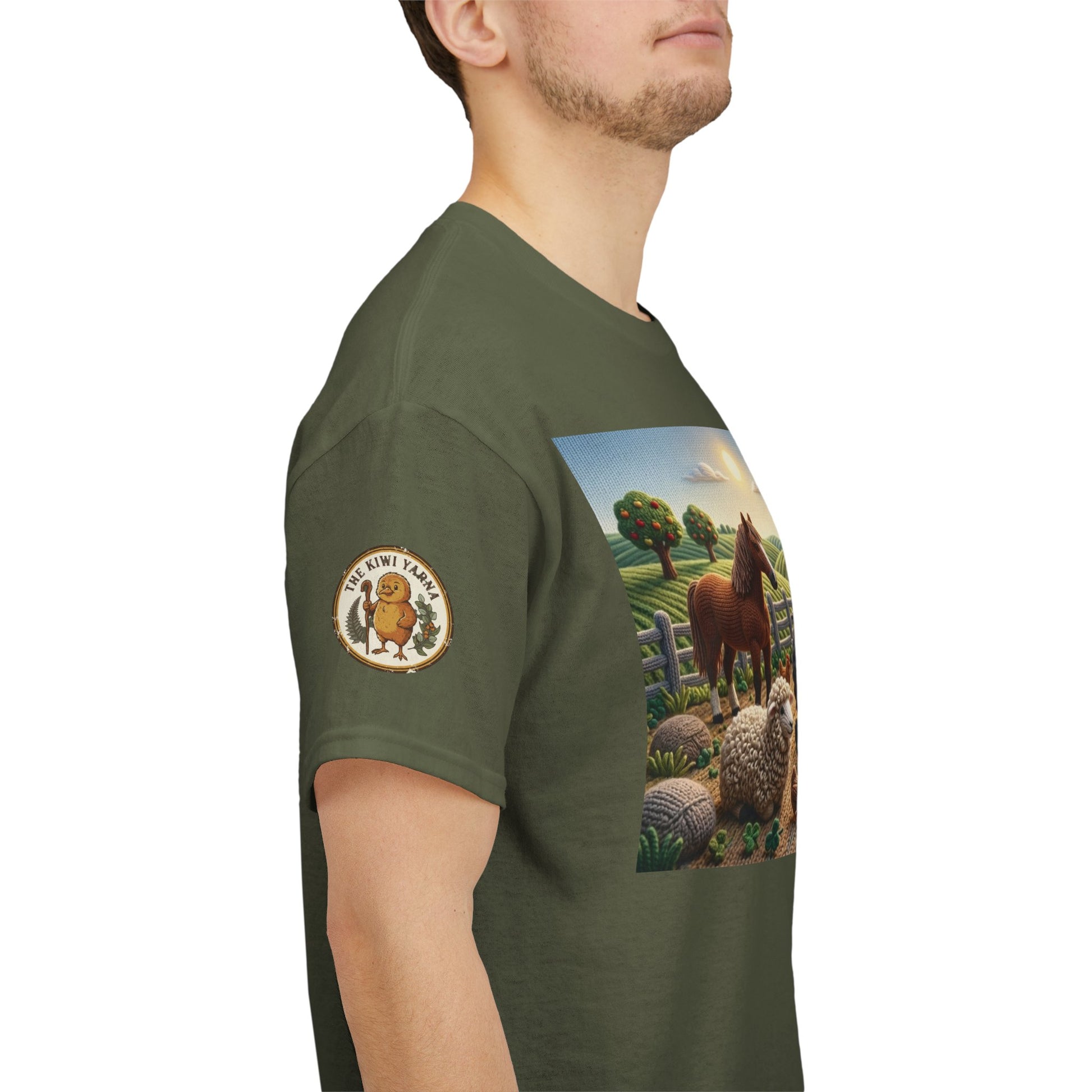 Olive green T-shirt with farm scene panel graphic and round logo patch on left sleeve.