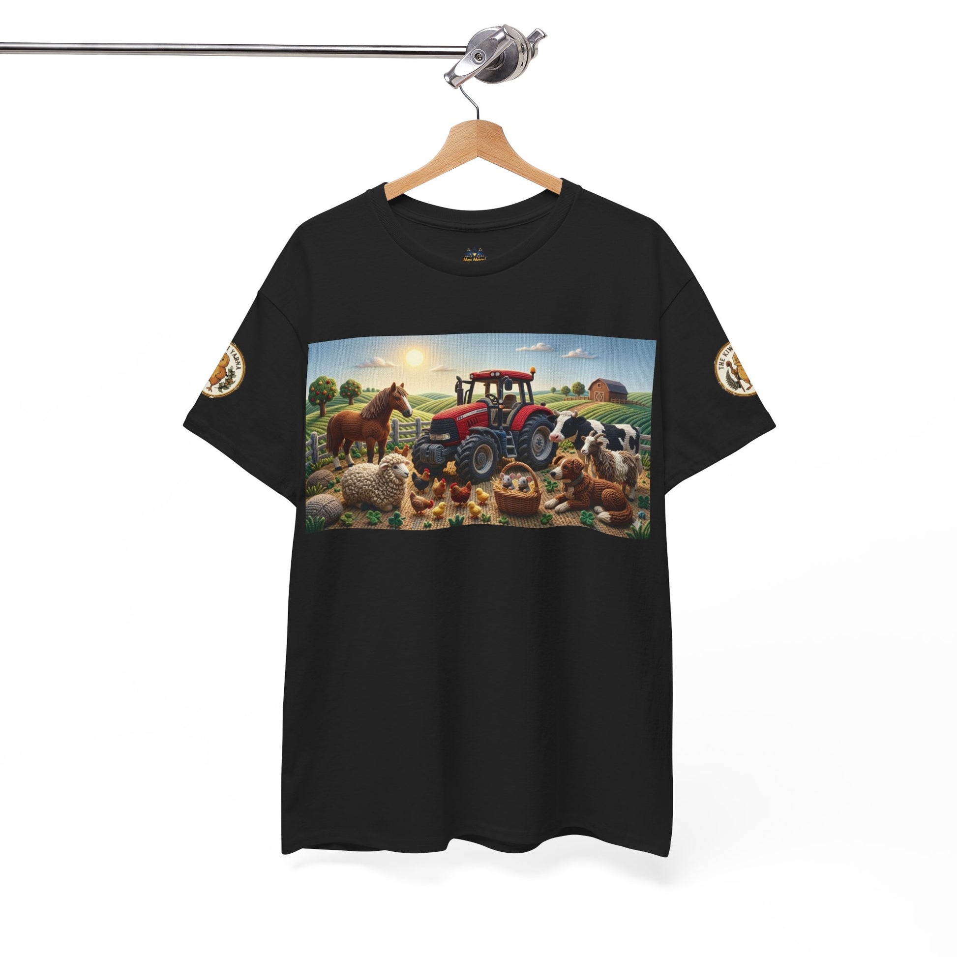 Black crewneck T-shirt with farm scene graphic on the front, hanging on a hanger