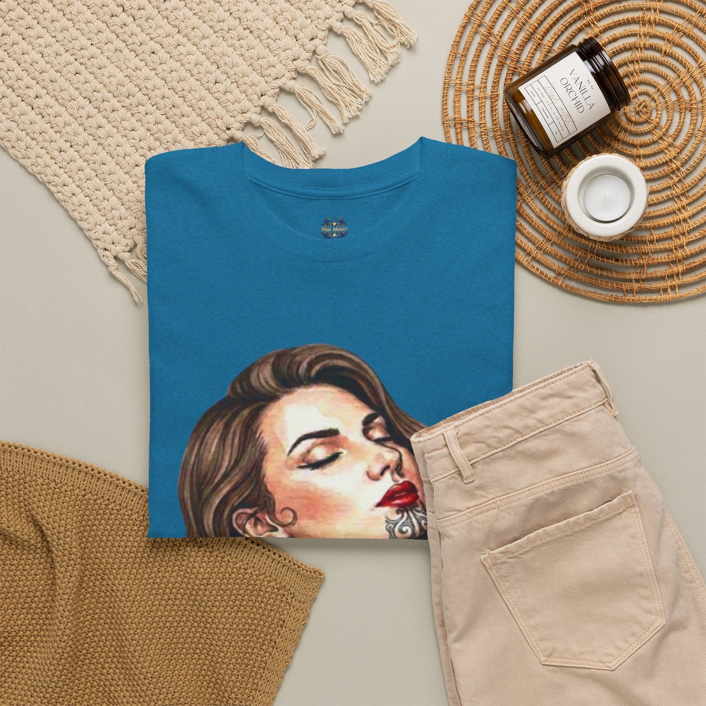 Teal graphic T-shirt with portrait print, small chest emblem, and crew neck