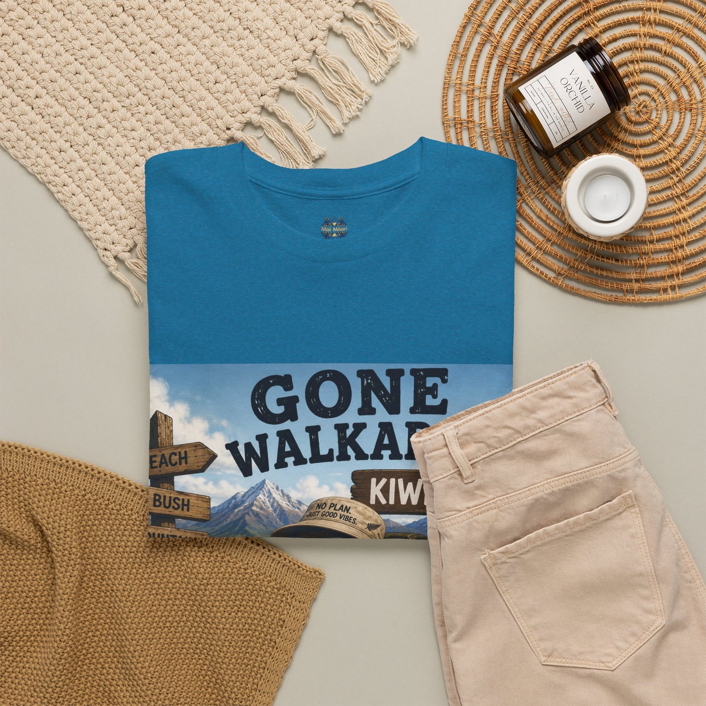 Teal short-sleeve crewneck T-shirt with kiwi-style adventure front graphic, flat lay.
