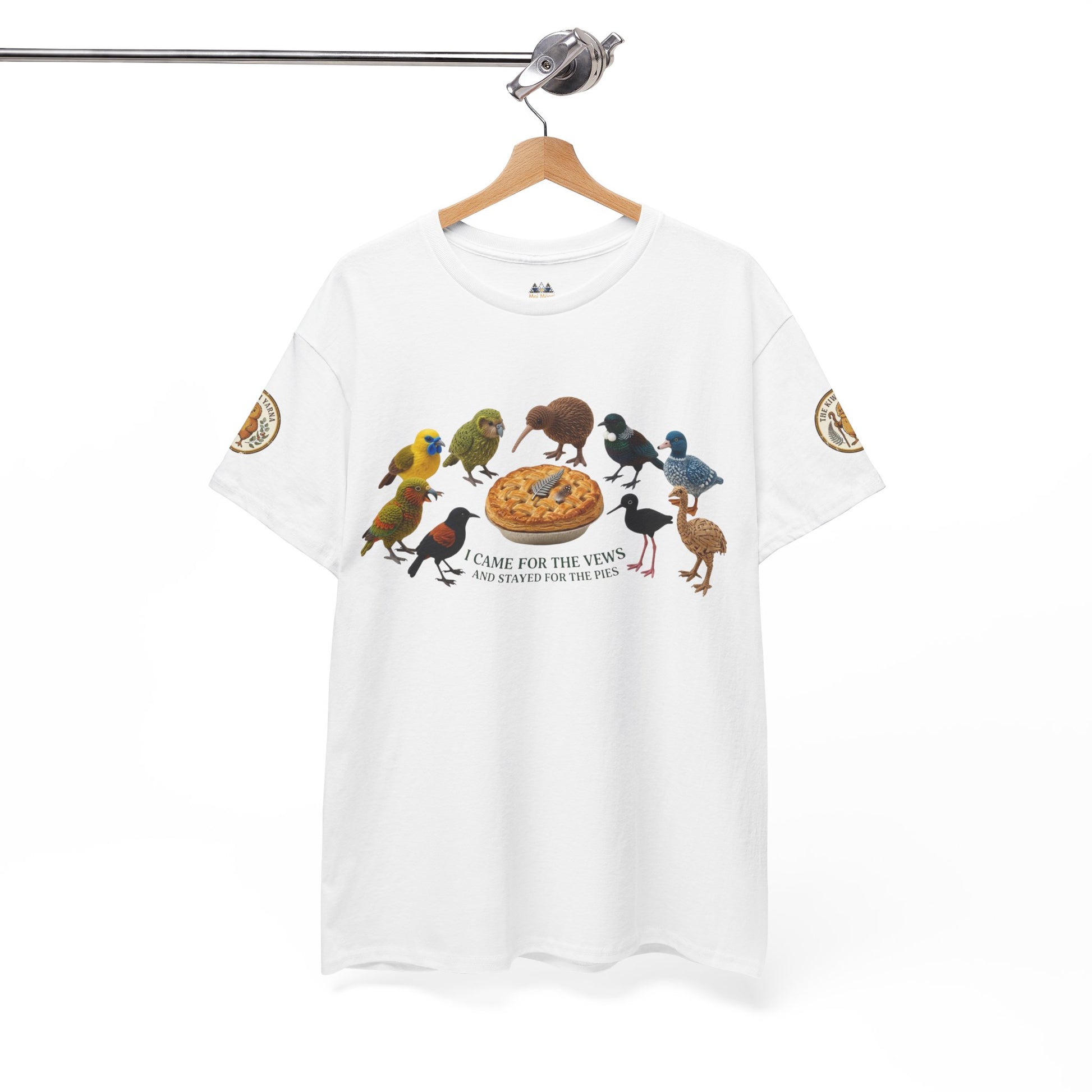 White T-shirt on hanger with birds and pie graphic, short sleeves with patch details.