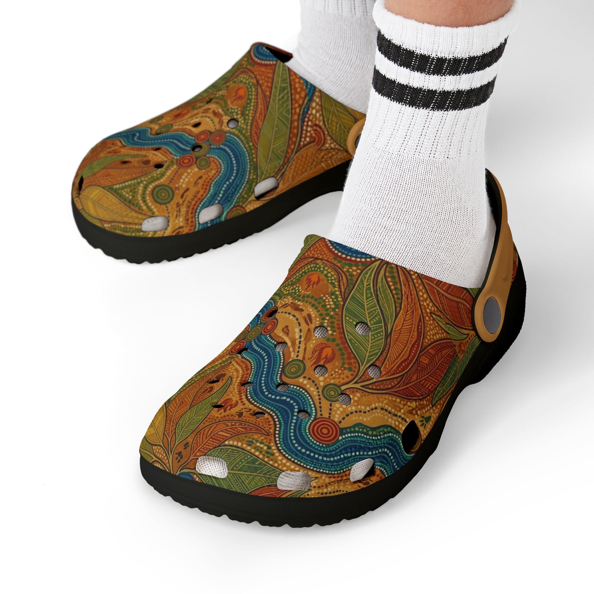 Aboriginal art slip-on clog shoe on foot with white striped socks and multicolor upper
