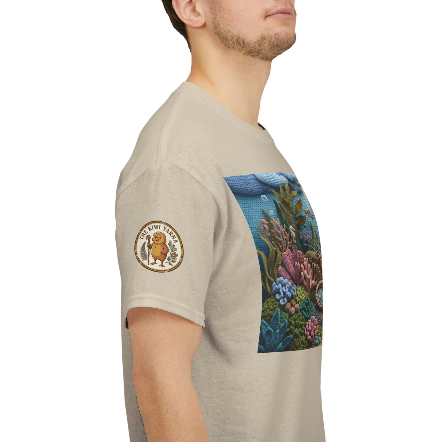 Under the sea T-shirt side view, light beige with sleeve emblem and ocean graphic panel