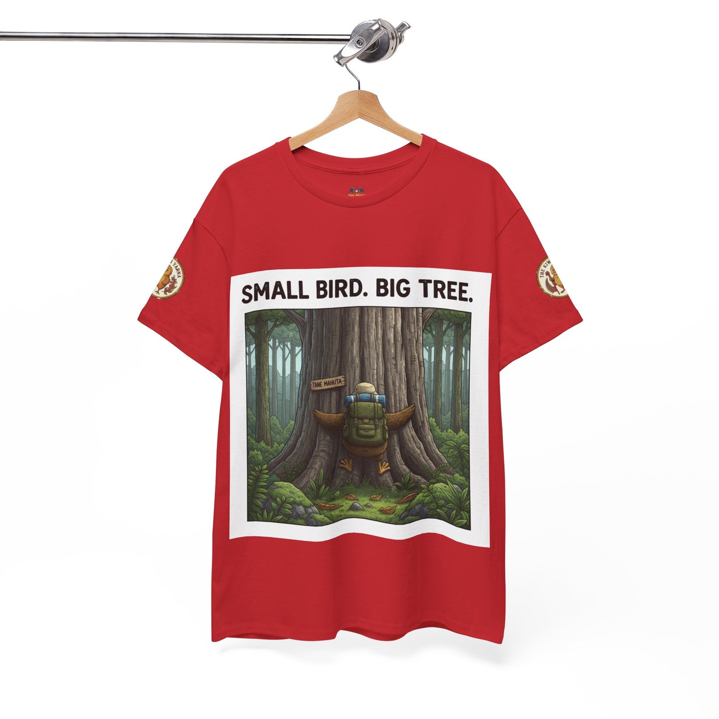 Red graphic t-shirt hanging with 'Small Bird. Big Tree.' tree print