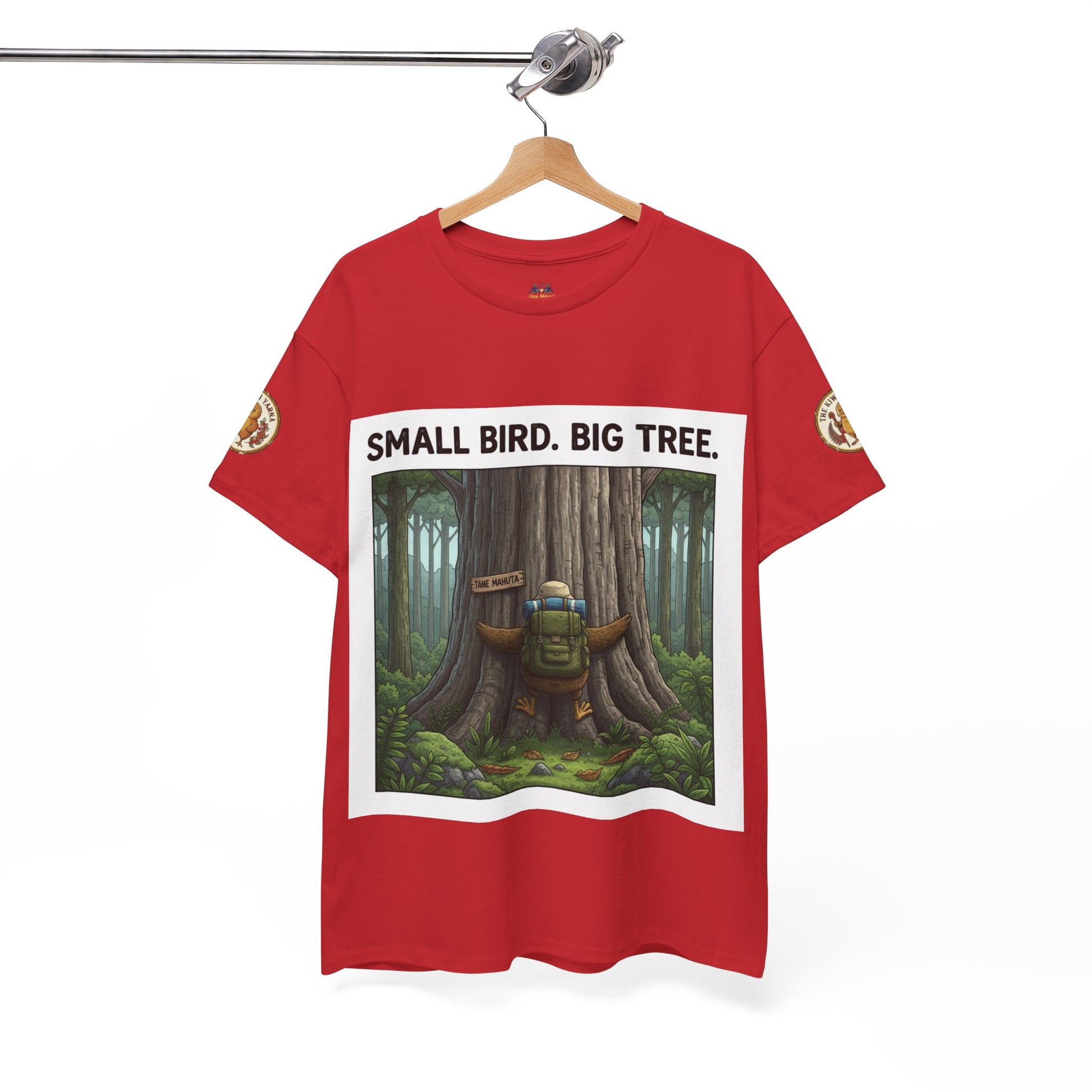 Red graphic t-shirt hanging with 'Small Bird. Big Tree.' tree print