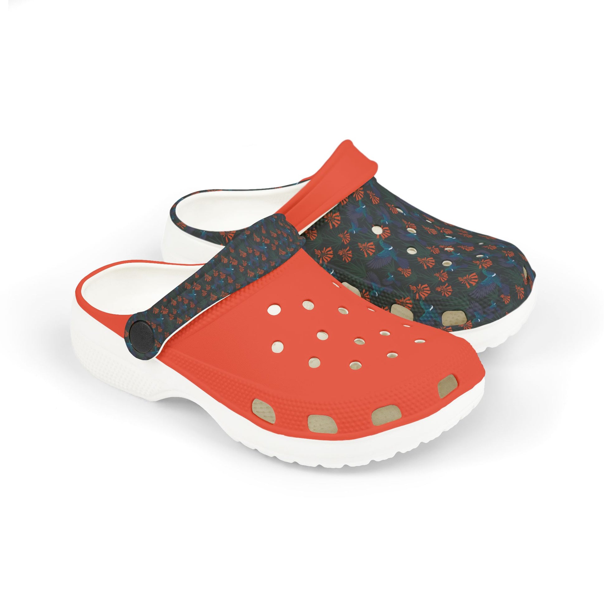 Kids slip-on clogs with white sole, dark floral upper, orange front panel and vent holes