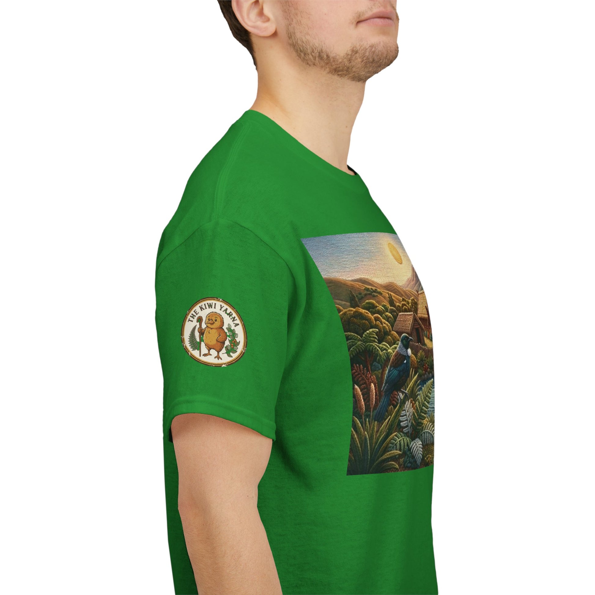 Green crewneck T-shirt side view with sleeve logo patch and landscape canoe graphic.