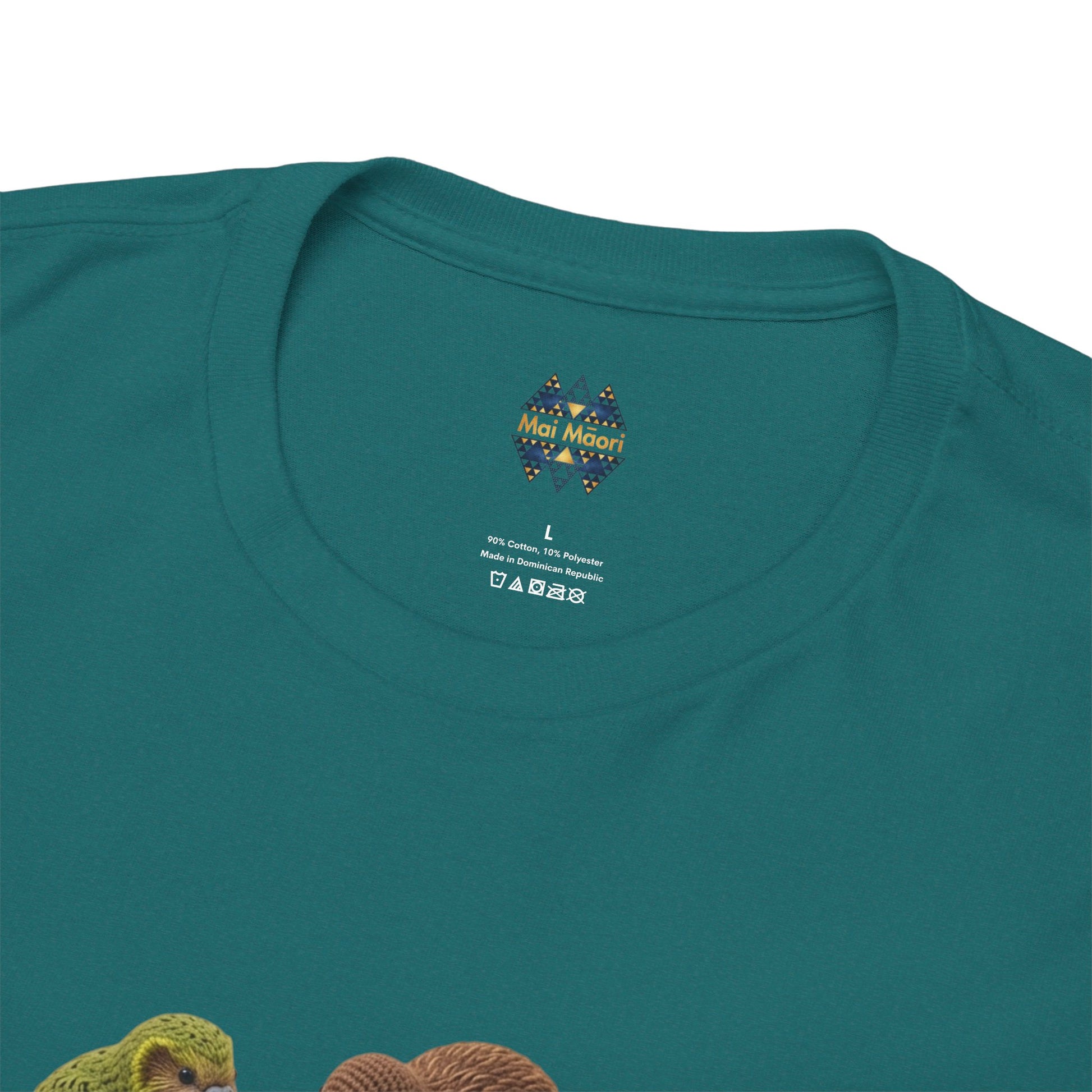 Teal T-shirt close-up: crew neck label above colorful bird and pizza graphic