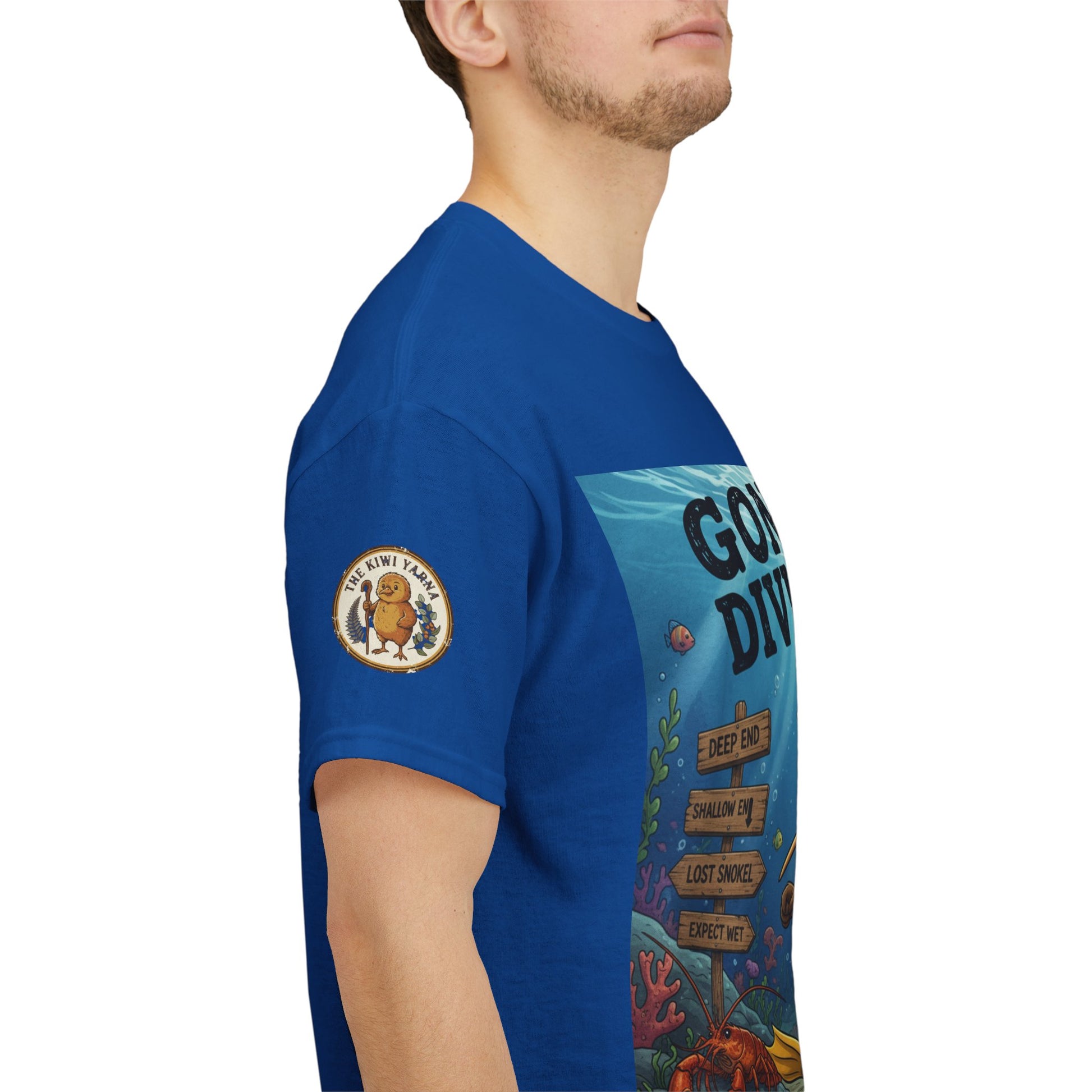 Blue crew-neck graphic t-shirt side view with sleeve patch and partial underwater print