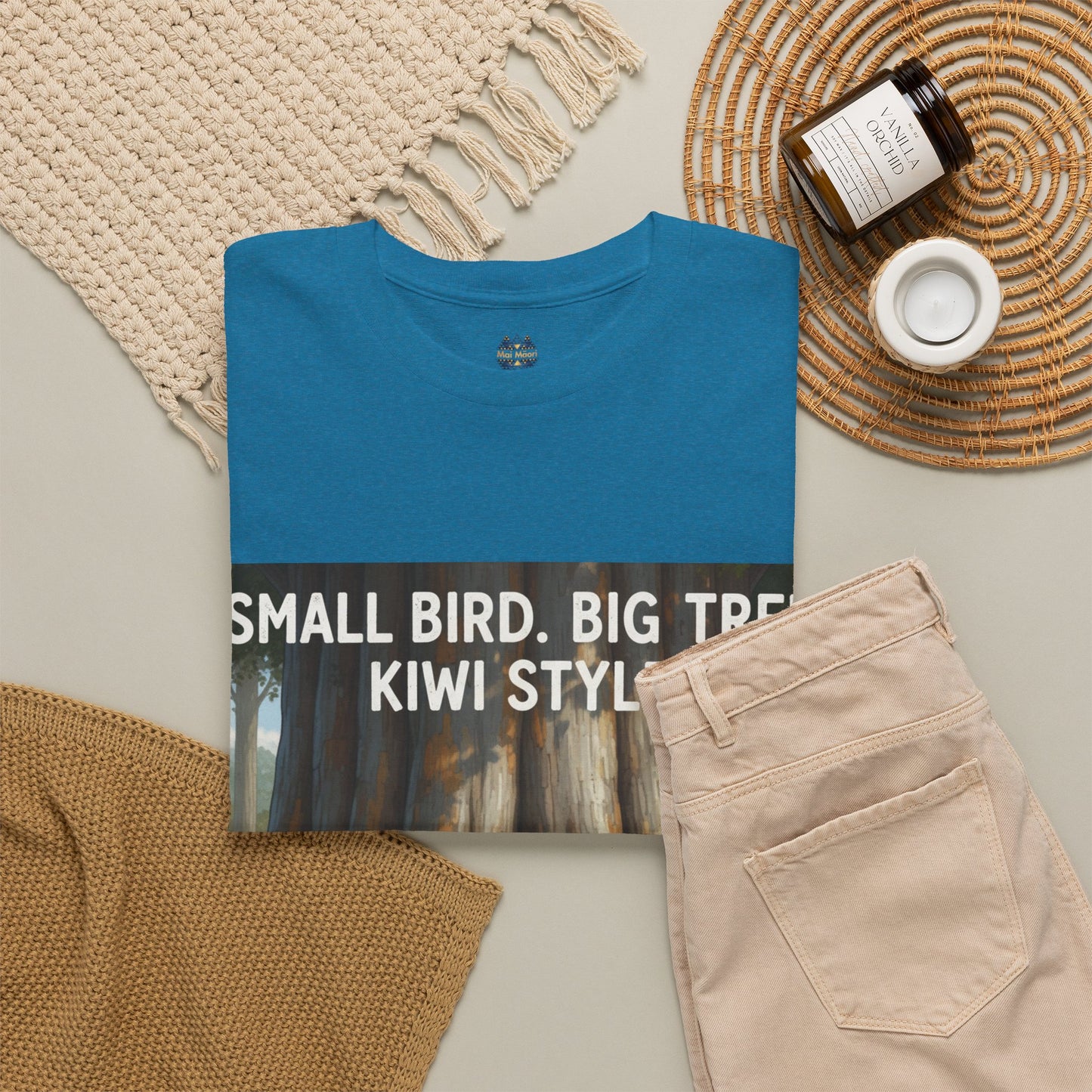Teal graphic T-shirt with front poster print, shown with beige pants
