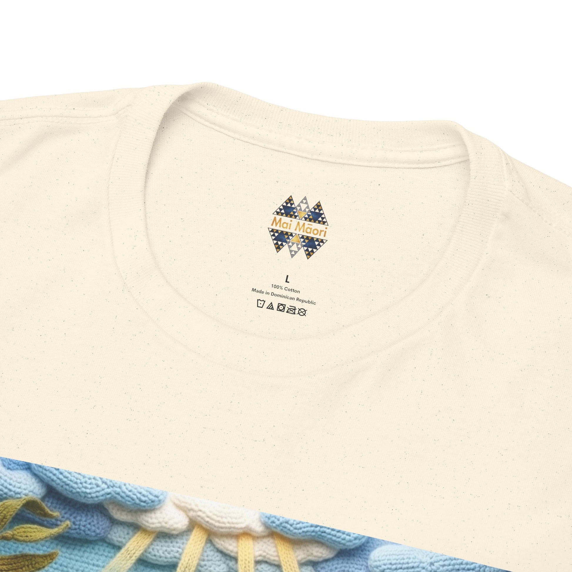 Close-up of off-white T-shirt neckline with small chest logo and ocean print edge