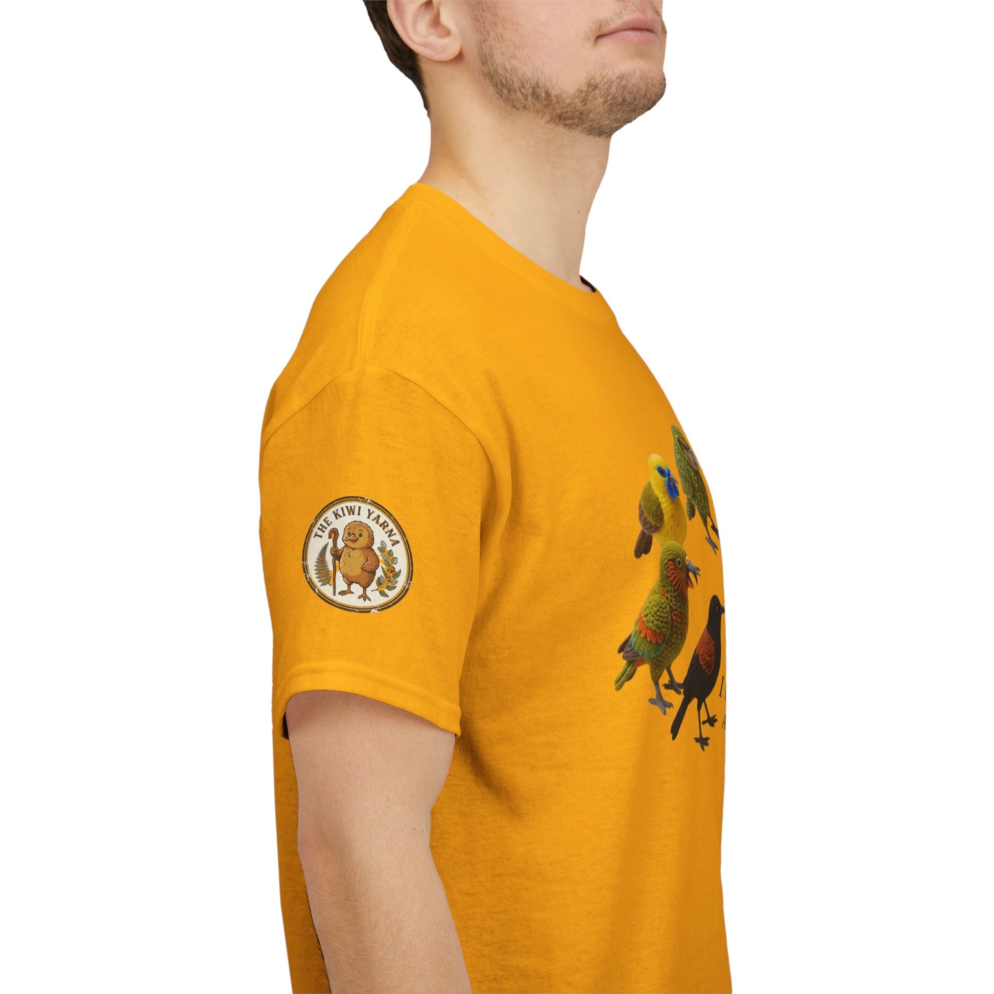 Side view of yellow T-shirt with circular sleeve patch and bird graphic