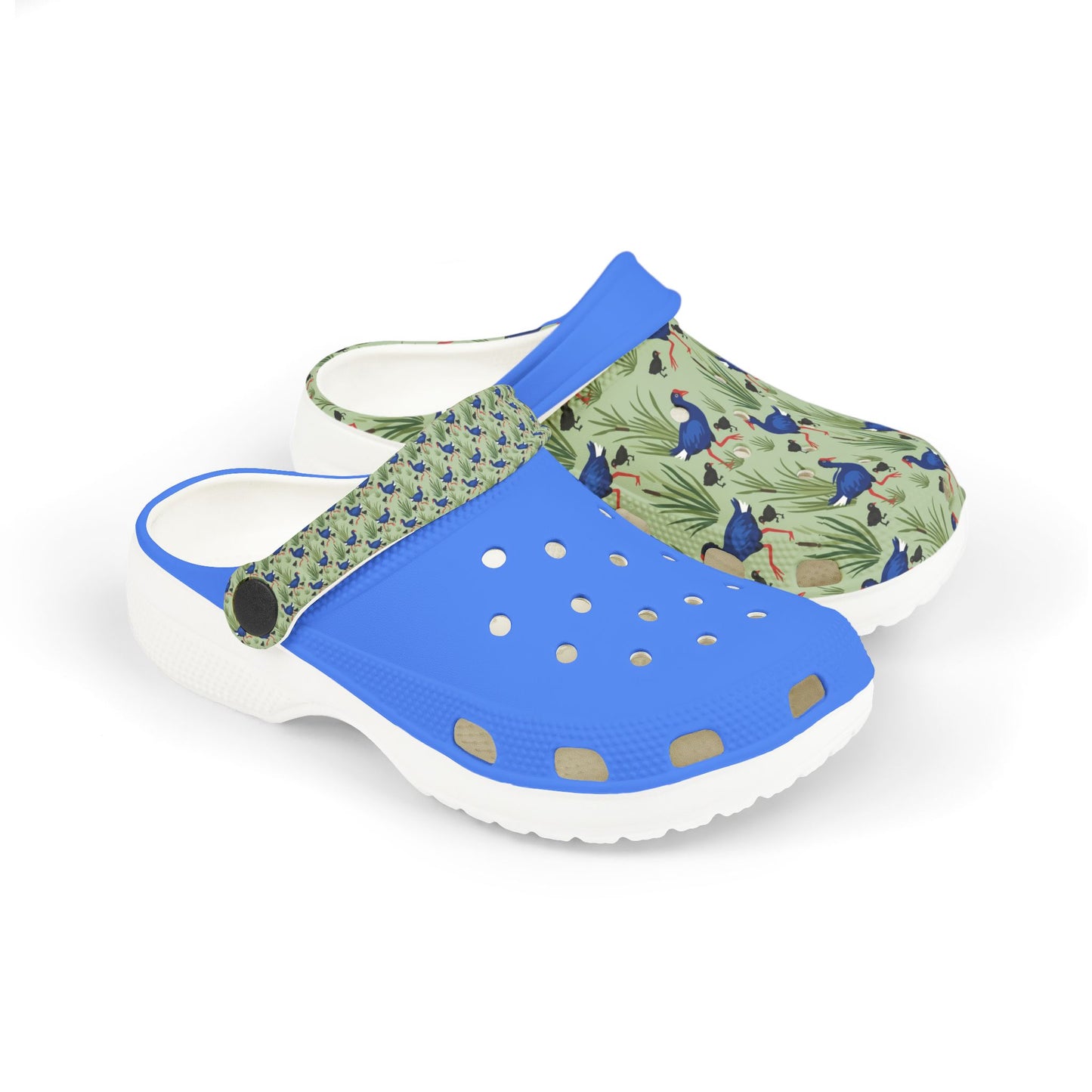 Kids clog shoes with blue top strap, green animal print upper, and chunky white sole.