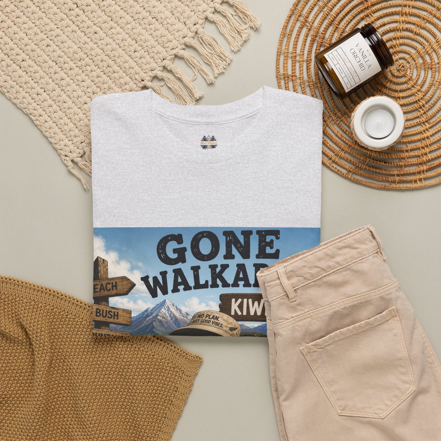 White crew-neck T-shirt with small chest icon and partial kiwi graphic