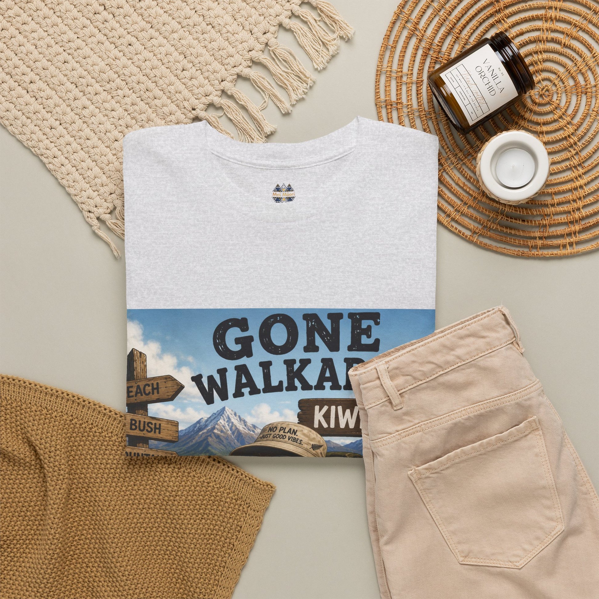 White crew-neck T-shirt with small chest icon and partial kiwi graphic
